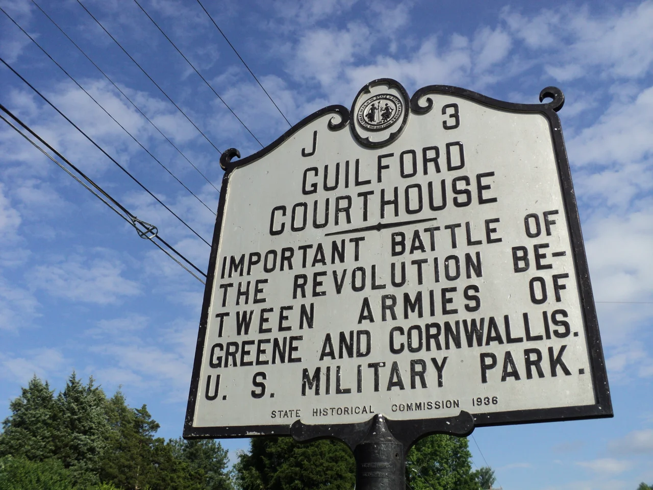 North Carolina state historical marker for Guilford Courthouse, located within the boundaries of present-day Greensboro, North Carolina. Guilford Courthouse was the site of a major battle of the American Revolution, when forces under American General Nathanael Greene confronted the troops of British General Lord Cornwallis. The site of the battlefield is today a United States Military Park.