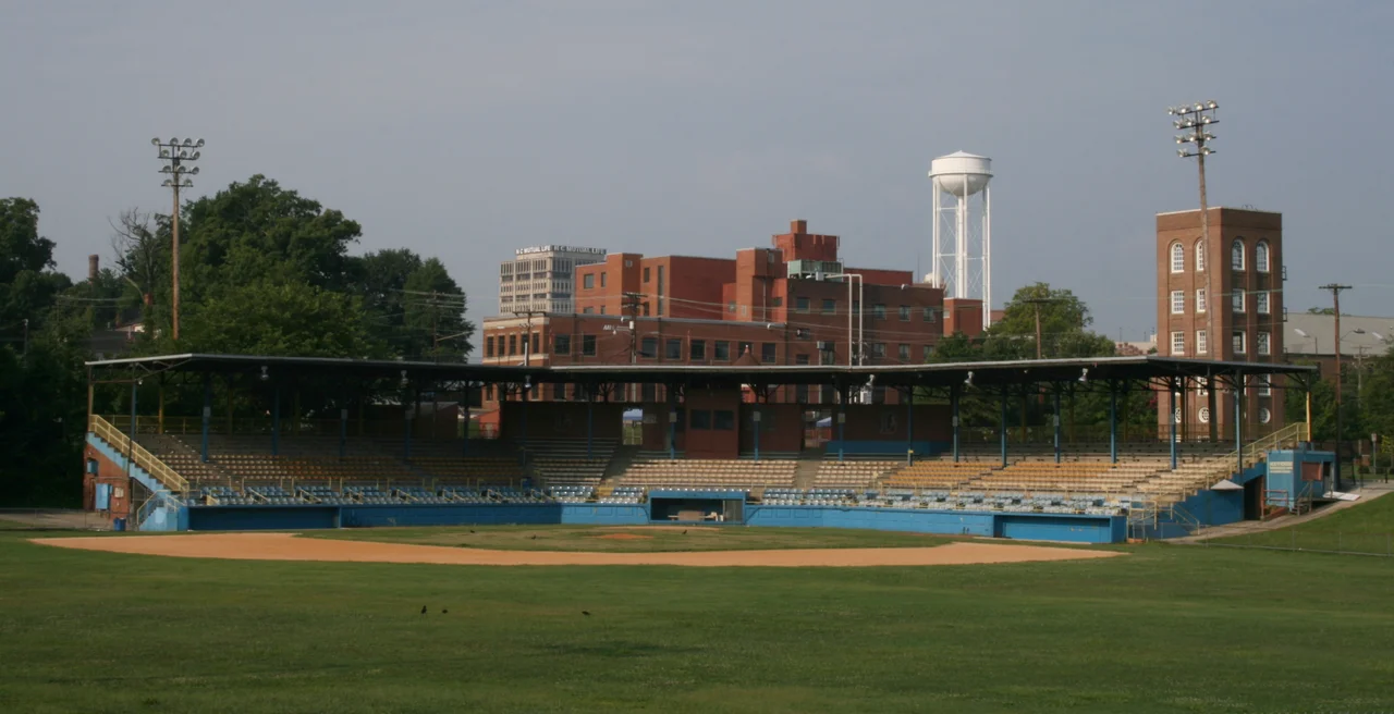 Durham Athletic Park in Durham, North Carolina.  In the background are the headquarters of Measurement Incorporated and the North Carolina Mutual Life Insurance Company Building.