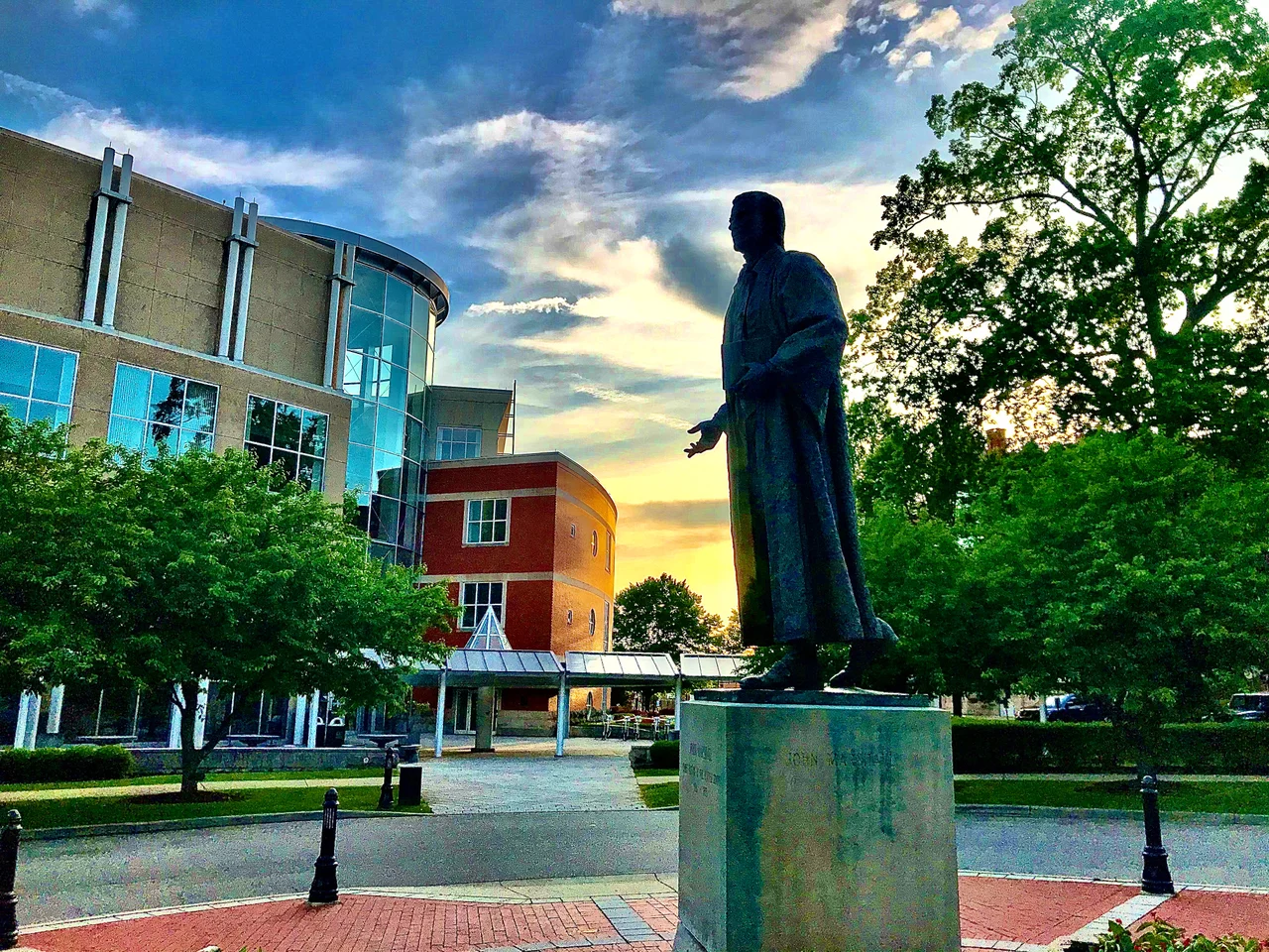 Sunset behind the John Marshall Statue and the Drinko Library on the campus of Marshall University in Huntington, WV 2020.