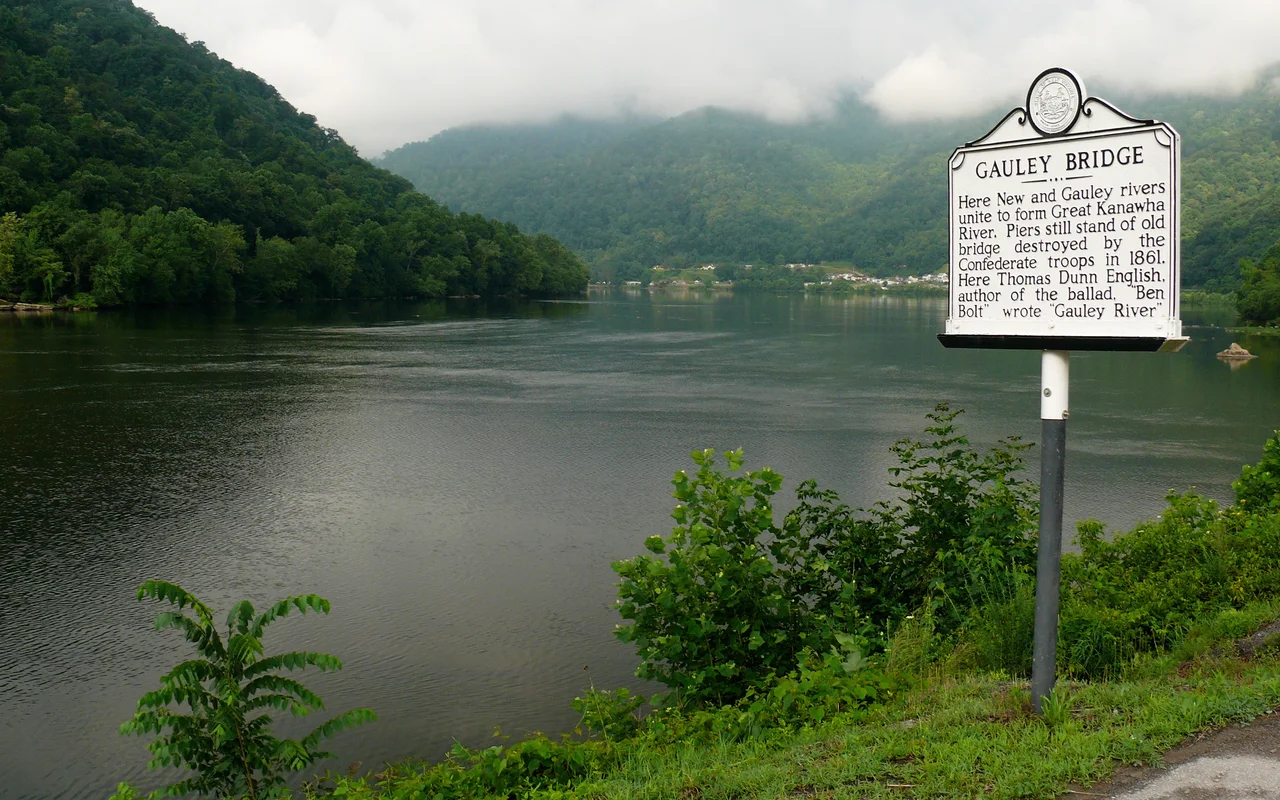 The confluence of the New River and the Gauley River, forming the Kanawha River at the town of Gauley Bridge. In the photo, the Gauley River flows in from the right (north), the New River flows in from the left (southwest), and the Kanawha River flows directly away (west) from the camera.Photo taken with a Panasonic Lumix DMC-FZ50 in Fayette County, WV, USA.