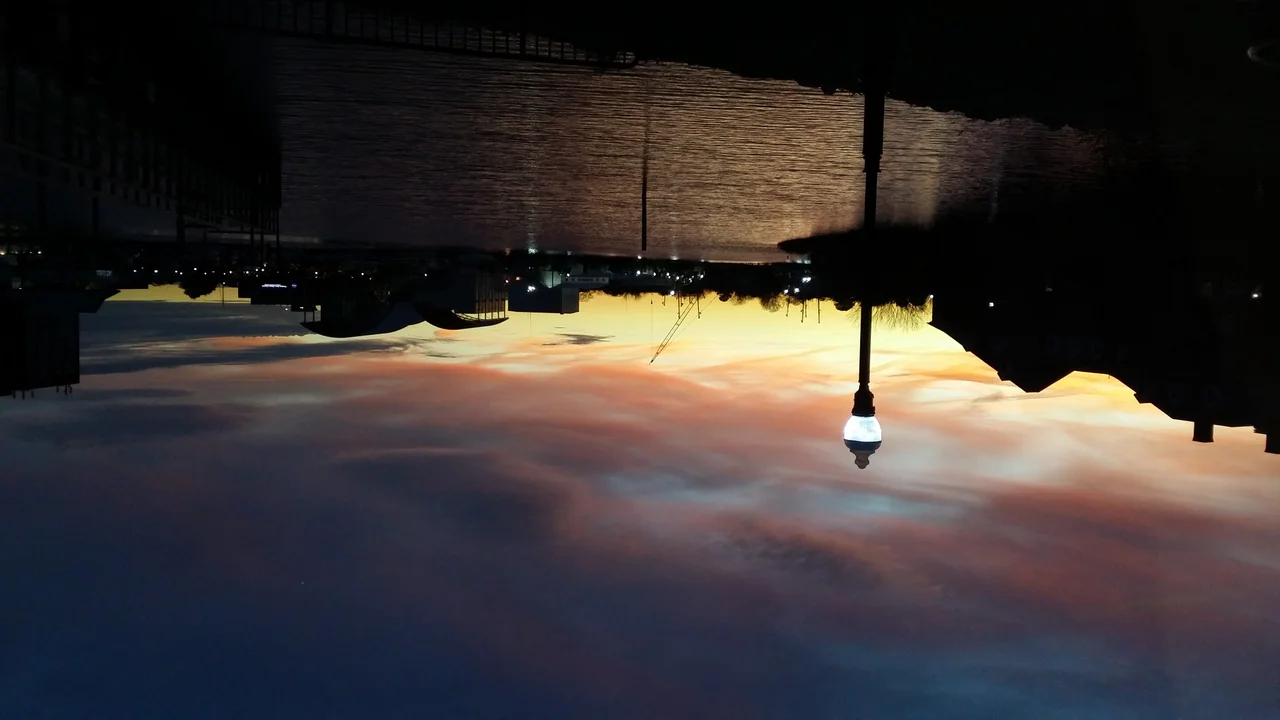 Sunset at Hampton University Cafeteria Waterfront in mid-December. We can see an estuary with beautiful reflection and a sky filled up with amazing unusual colors