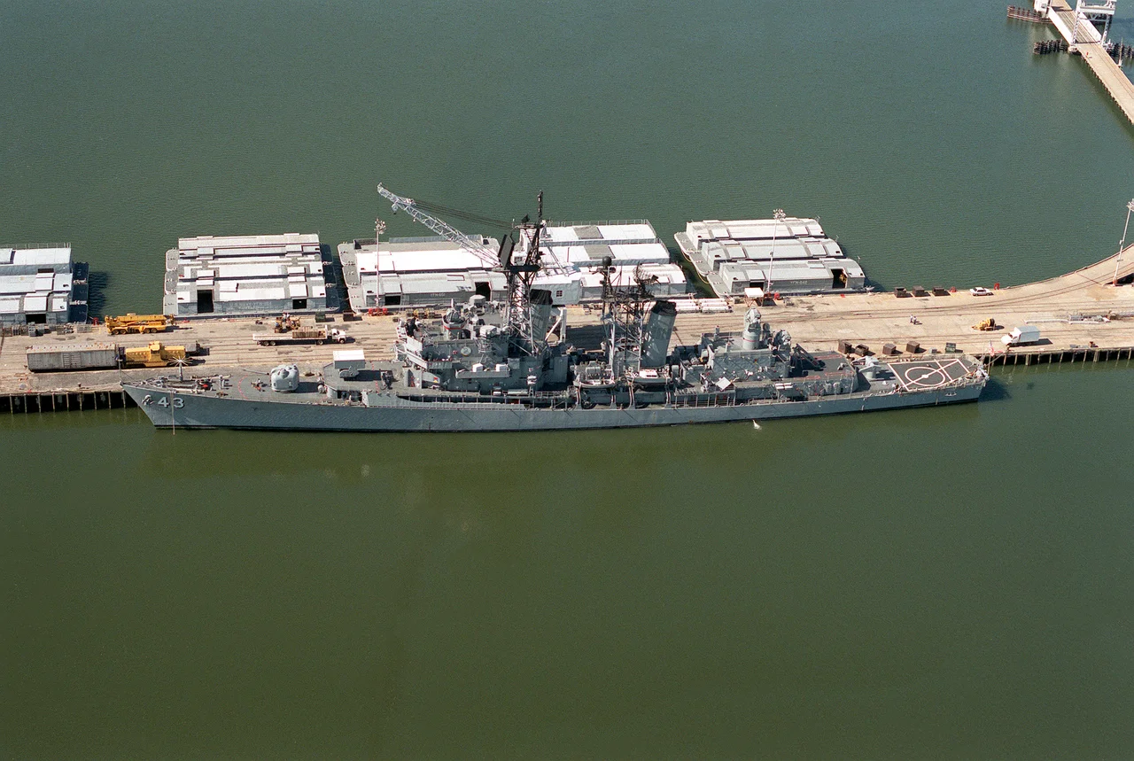 The U.S. Navy guided missile destroyer USS Dahlgren (DDG-43) tied up to a pier at the Naval Weapons Station Yorktown, Virginia (USA), in 1990.