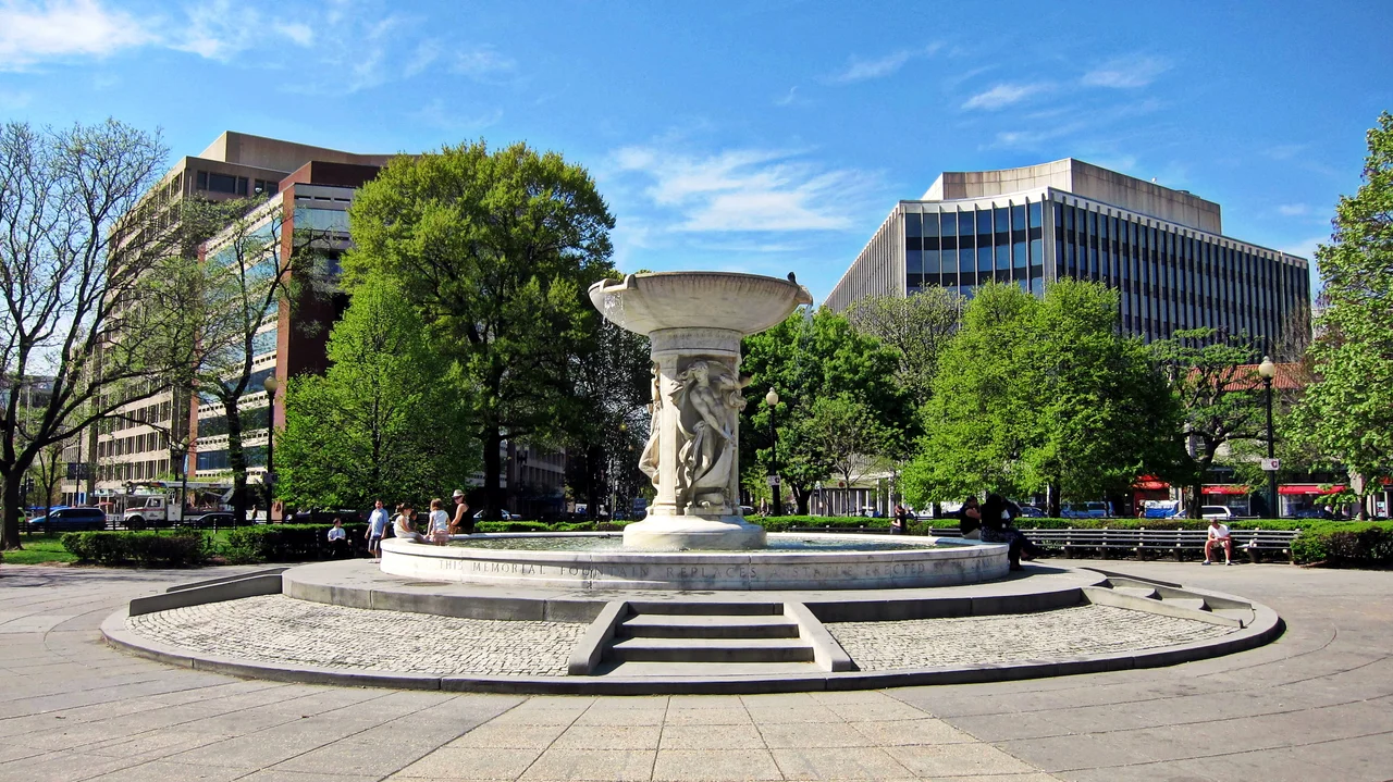 The Dupont Circle fountain, located at the center of Dupont Circle in Washington, D.C. Designed by Henry Bacon and sculpted by Daniel Chester French, the marble fountain is in honor of Rear Admiral Samuel Francis Du Pont. The fountain's shaft features carvings of three classical nudes symbolizing the sea, the stars, and the wind. Sculpted in 1921, the fountain is designated a contributing property to the Dupont Circle Historic District, listed on the National Register of Historic Places in 1978.
