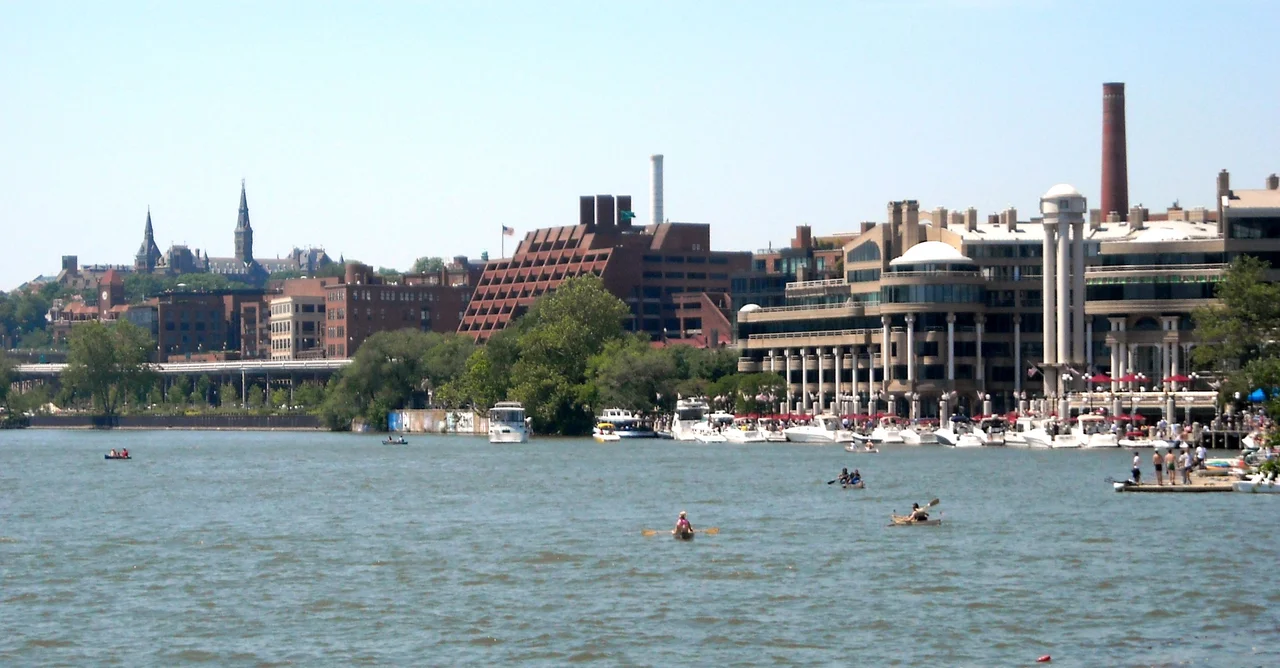 Washington Harbour in Washington, D.C.  The two spires of Georgetown University's Healy Hall are visible in the background on the left-hand side.