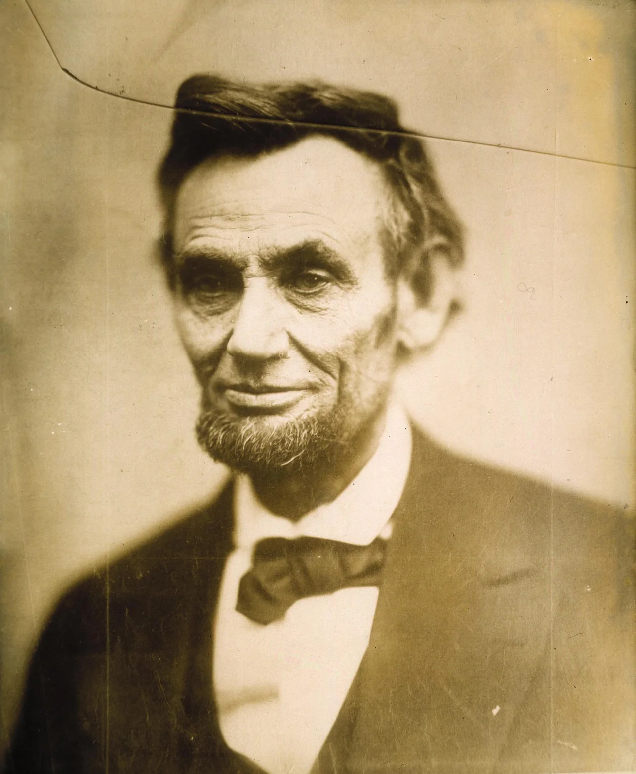 On Sunday, February 5, 1865, at Gardner's Gallery in Washington DC, Alexander Gardner took several multiple-lens pictures of the President. Before this session ended, Gardner asked the president for one last pose. He moved his camera closer and took a photograph of Lincoln’s head, shoulders, and chest. Mysteriously the glass plate negative cracked. Gardner carefully took it to his dark room and was able to make one print, with an ominous crack across Lincoln’s face, before it broke completely and was discarded. This print, known as O-118, still exists to this day. Over the years many people have associated this crack with a symbolic foretelling of the assassin’s bullet that awaited Lincoln 10 weeks later.