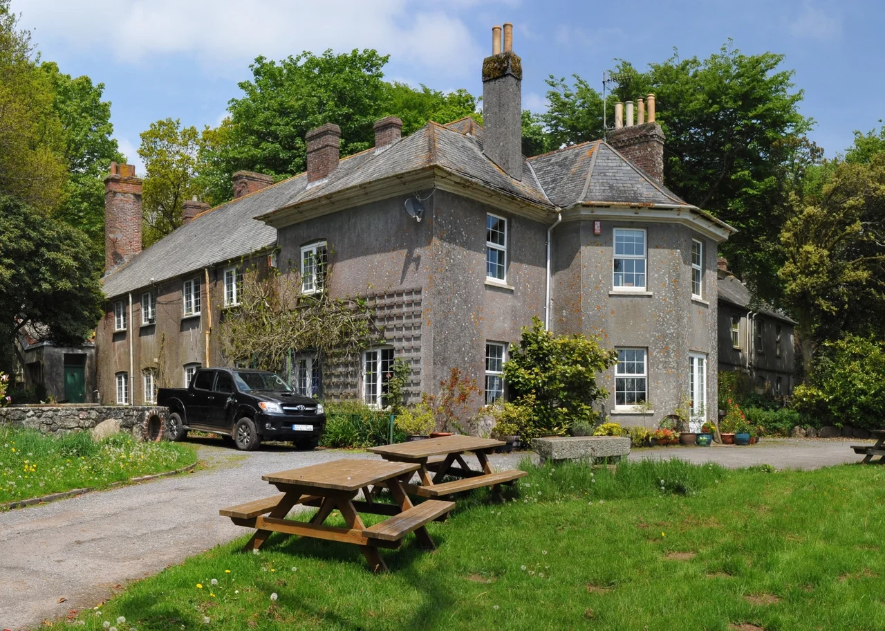The house at Dartmoor Zoological Park in 2010. The plaque under the trees at the far left reads "ELLIS BOWEN DAW - Born 15th September 1928 - FOUNDER OF DARTMOOR WILDLIFE PARK 29 JUNE 1968 - Here's to those who wish me well and those who don't can go to hell!"
