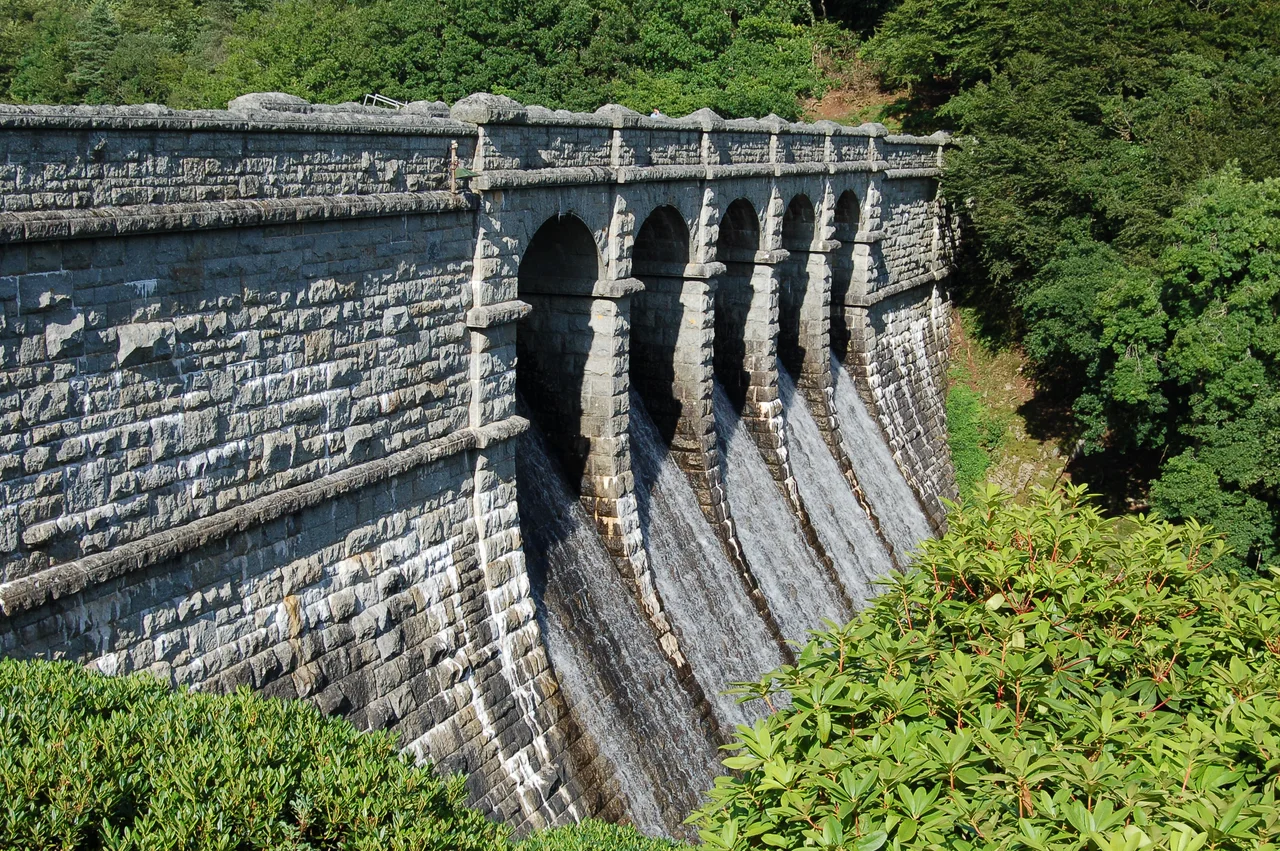 The main dam of the Burrator reservoir taken from its western most end. The reservoir is overflowing due to heavy rain in the previous weeks.