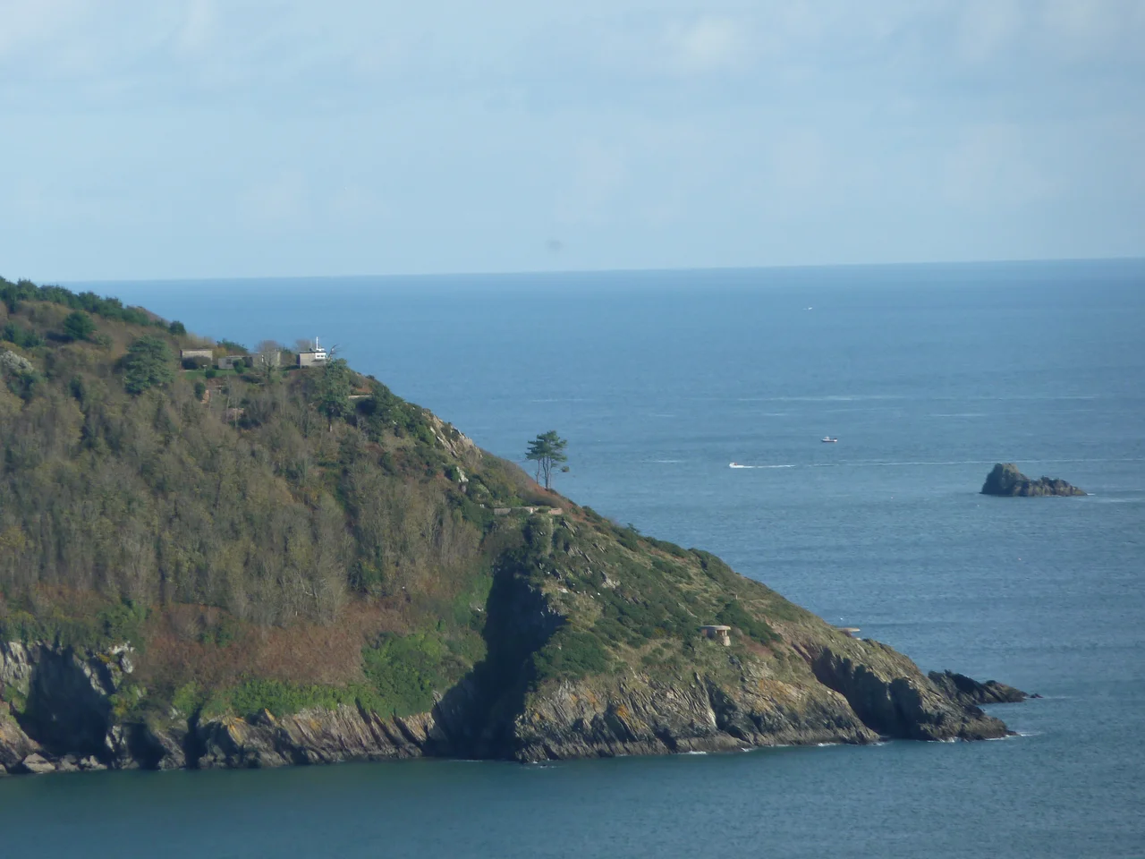 NCI Froward Point Taken from across the mouth of the River Dart. The lookout is part of the Brownstone Battery complex, a World War 2 battery, now derelict and owned by the National Trust. Clearly visible are the battery observation post (with the flagpole near the top of the headland), two searchlight positions as close to sea level as possible, one concrete gun emplacement, and sundry other buildings and concrete constructions