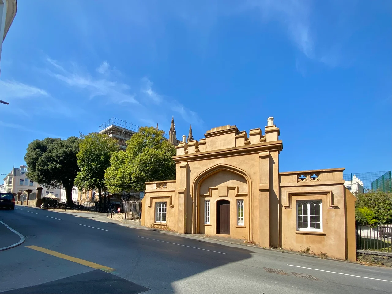 A photograph of the gatehouse forming part of an early 19th century building and surrounding buildings and land, which comprise the main site of Elizabeth College, Guernsey, as viewed from opposite at the end of Sausmarez Street.