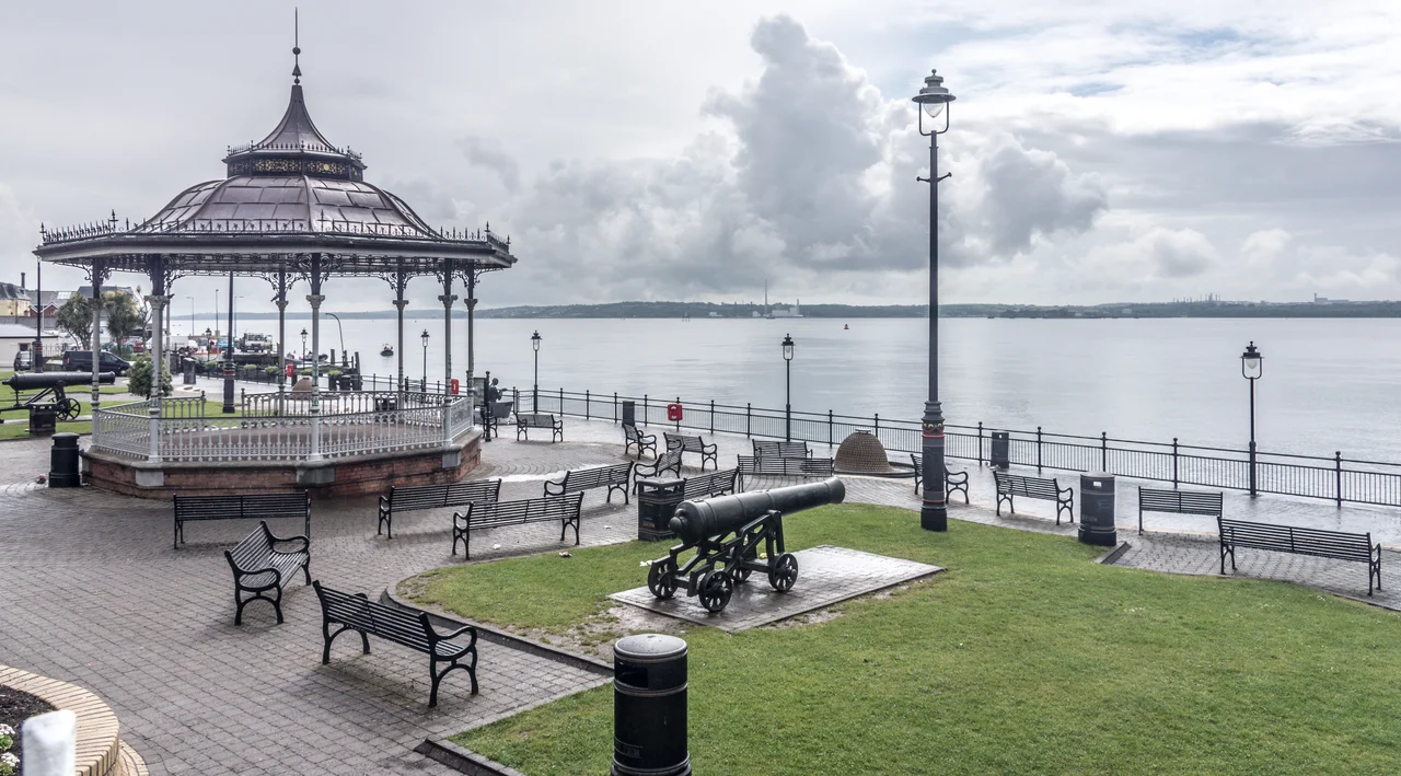 Cobh  (pronounced Cove) dominates Cork Harbour one of the largest natural harbours in the world. This colourful town has experienced invasion, emigration, transportation and a wealth of maritime adventure.
Attractions in the town include St. Colman's Cathedral, a magnificent 19th century Gothic revival and home to the largest Carillon (49-bells), in Ireland and the UK. The Cathedral Spire overlooks the brightly painted town of Cobh and the inner islands of the harbour, Spike Island, renowned for its historical legacy and Fort and Haulbowline Island site of the oldest yacht club in the world, the Royal Cork Yacht Club which was founded in 1720.
Cobh  became the country's main emigration port following the Great Famine of 1846 - 1848 Following the visit of Queen Victoria in 1849, the town was renamed Queenstown but in 1921, it reverted to the old name of Cobh.

On the shoreline, a statue memorialises Annie Moore, the first immigrant to disembark at Ellis Island. Coffin and prisoner ships, bound for the southern hemisphere, all embarked from this shoreline. The Titanic's last port of call was Cobh and the ill-fated Lusitania also has a tragic association with the town. Cobh's unique origins are dramatically recalled in the Queenstown Story, on the Titanic Trail and at the Cobh Museum. The Cobh Heritage Centre also offers a Genealogy service