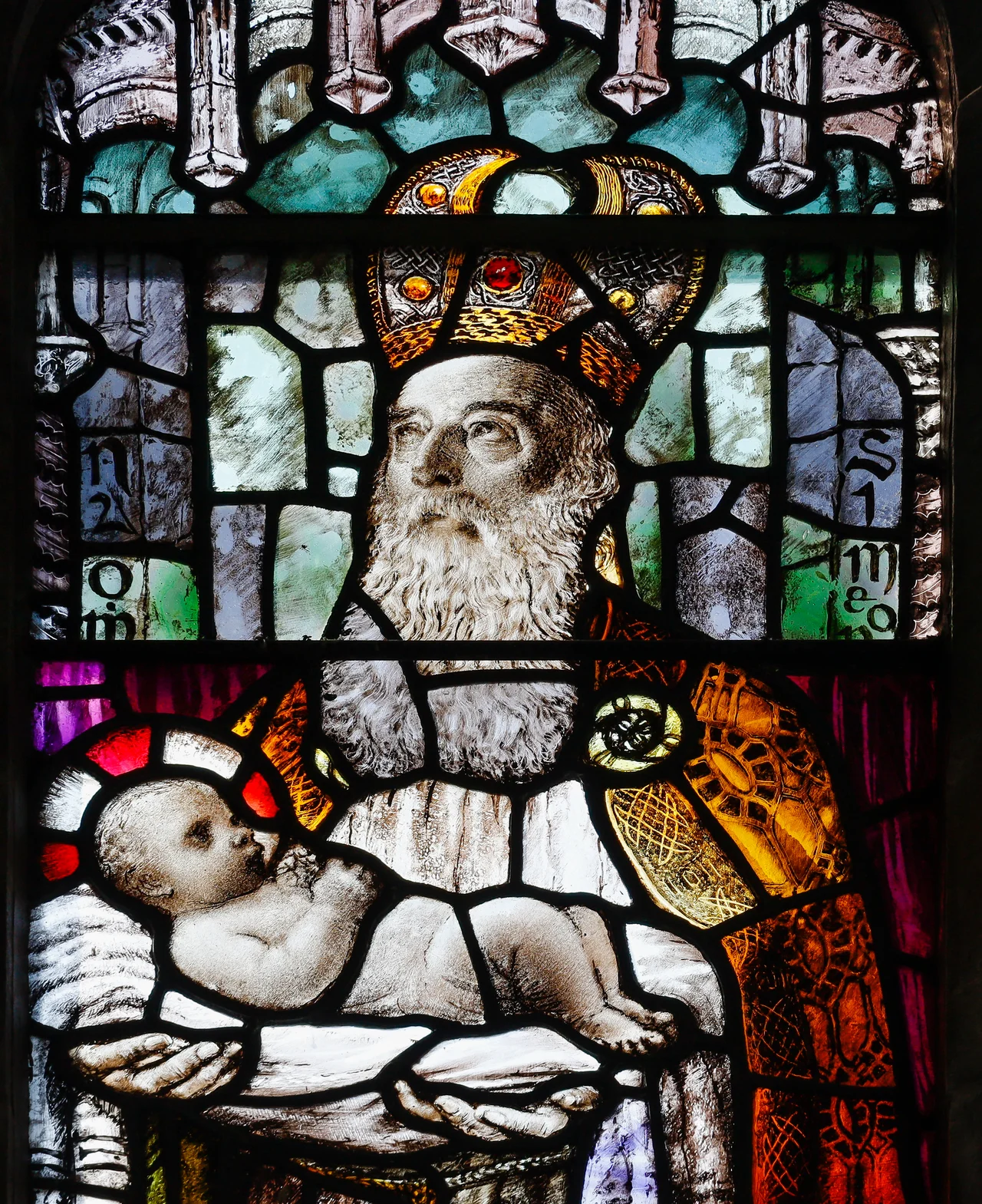 Detail of the stained glass window in the baptistry by Michael Healy (1873–1941), depicting Simeon holding Jesus Christ. This work was created in 1904 in the An Túr Gloine workshop in Dublin. (See Nicola Gordon Bowe et al, Gazetteer of Irish Stained Glass, ISBN 0-7165-2413-9, p. 57; St Brendan's Cathedral, Loughrea, ISBN 0-900346-76-0.)