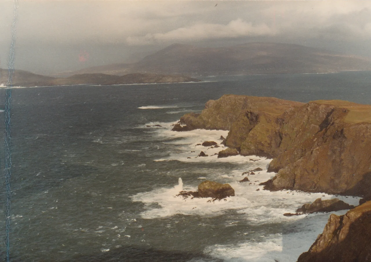 Digital recreation of The Coat of Arms ("crest") of County Mayo in the Republic of Ireland, based on the following official description:
"Per fess gules and argent in chief four crosses one and three the first patriarchal the others passion crosses or, in base on waves of the sea a lymphad proper, the whole within a bordure of the third charged with nine yew trees also proper, with the Crest: On a mount vert a garden rose slipped or and with the Motto: Dia is Muire linn."