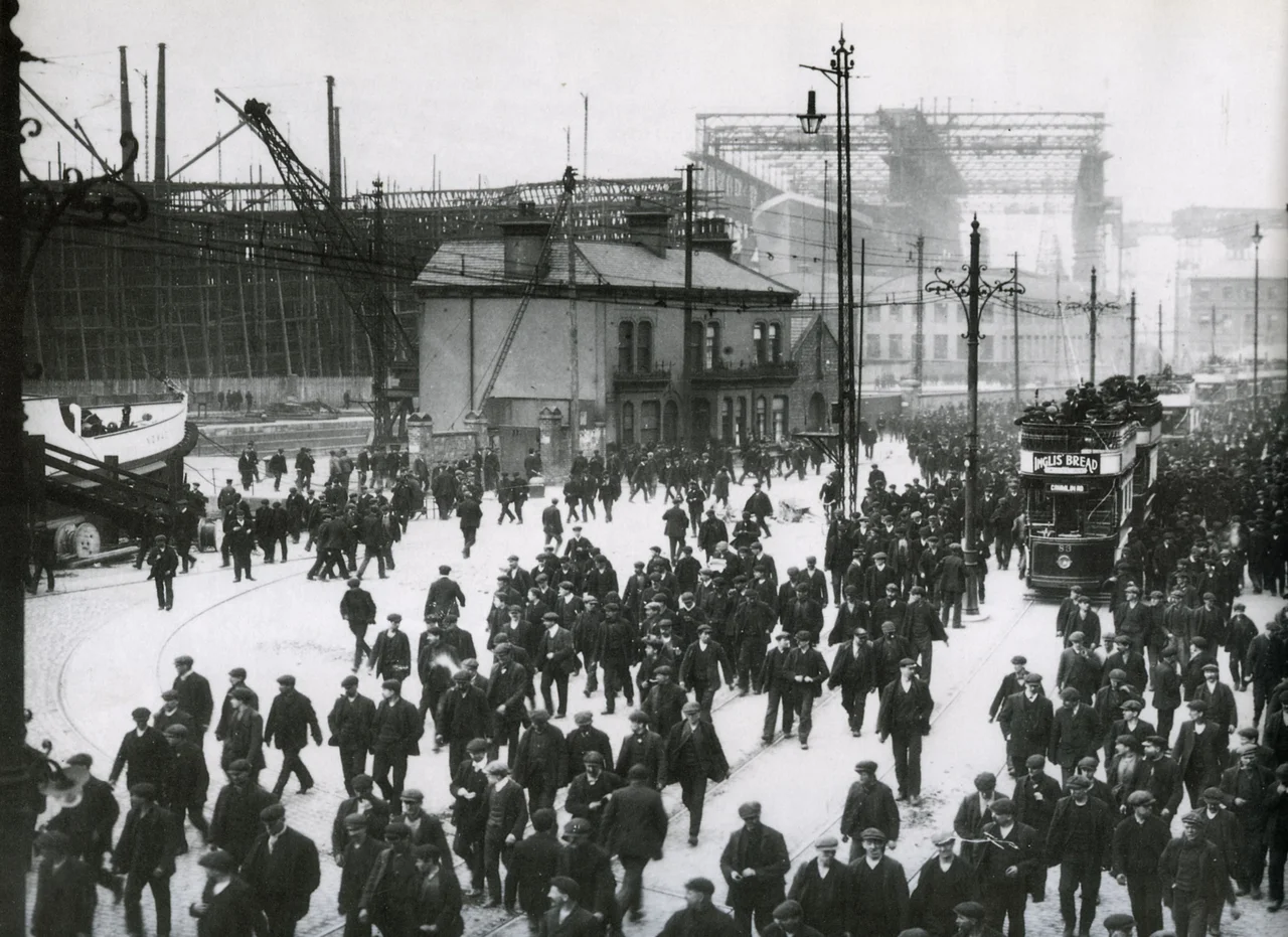 An image of knocking off time at Harland & Wolff, Belfast. The ship in the background is the Titanic.