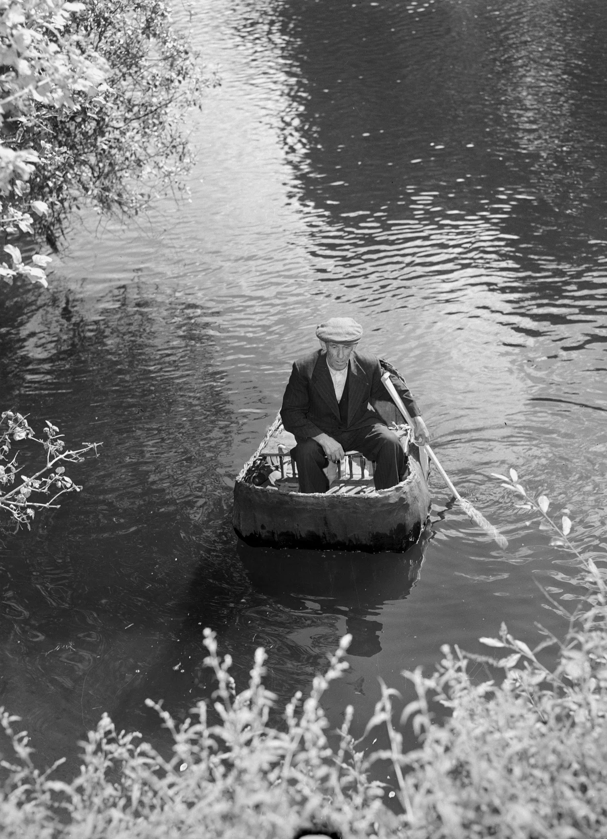 man and his coracle on the Teifi River, near Cardigan