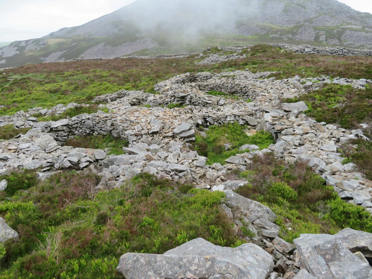 Inside the Celtic Iron Age hillfort of Tre'r Ceiri, Gwynedd Wales, with its 150 houses; finest in Europe
Inside the Celtic Iron Age hillfort of Tre'r Ceiri, Llithfaen, Gwynedd Wales, with its 150 huses. It is counted by many as one of the largest, best preserved and finest Iron Age hillforts in Northern Europe.

The settlement is located 450 metres (1,480 ft) above sea level on the slopes of Yr Eifl, a mountain on the north coast of the Llŷn Peninsula in Gwynedd, north-western Wales. According to Roman writers there were four different groups of Celts living in what is now Wales: the Silures lived in South Wales, and the Deceangli in North-East Wales, the Ordovices in Central North Wales and the Gangani in the Llŷn peninsula.