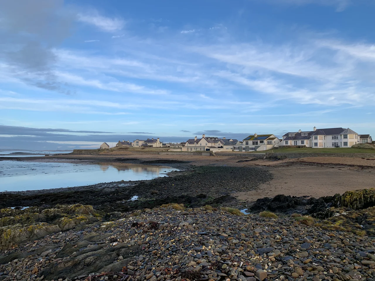 Photo was taken from Braich Parlwr, and shows Gardd Goffa Rhosneigr (Rhosneigr Memorial Garden) in the background, with the statue of Sir Max Horton