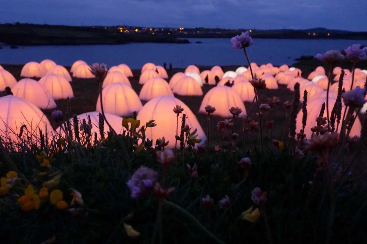 Part of the London 2012 Cultural Olympiad. Peace Camp was an installation at 8 coastal locations around Britain in which glowing dome tents and recitals of love poetry filled the site. This headland near St Patrick's Church, Cemaes Bay, was the Welsh  location.