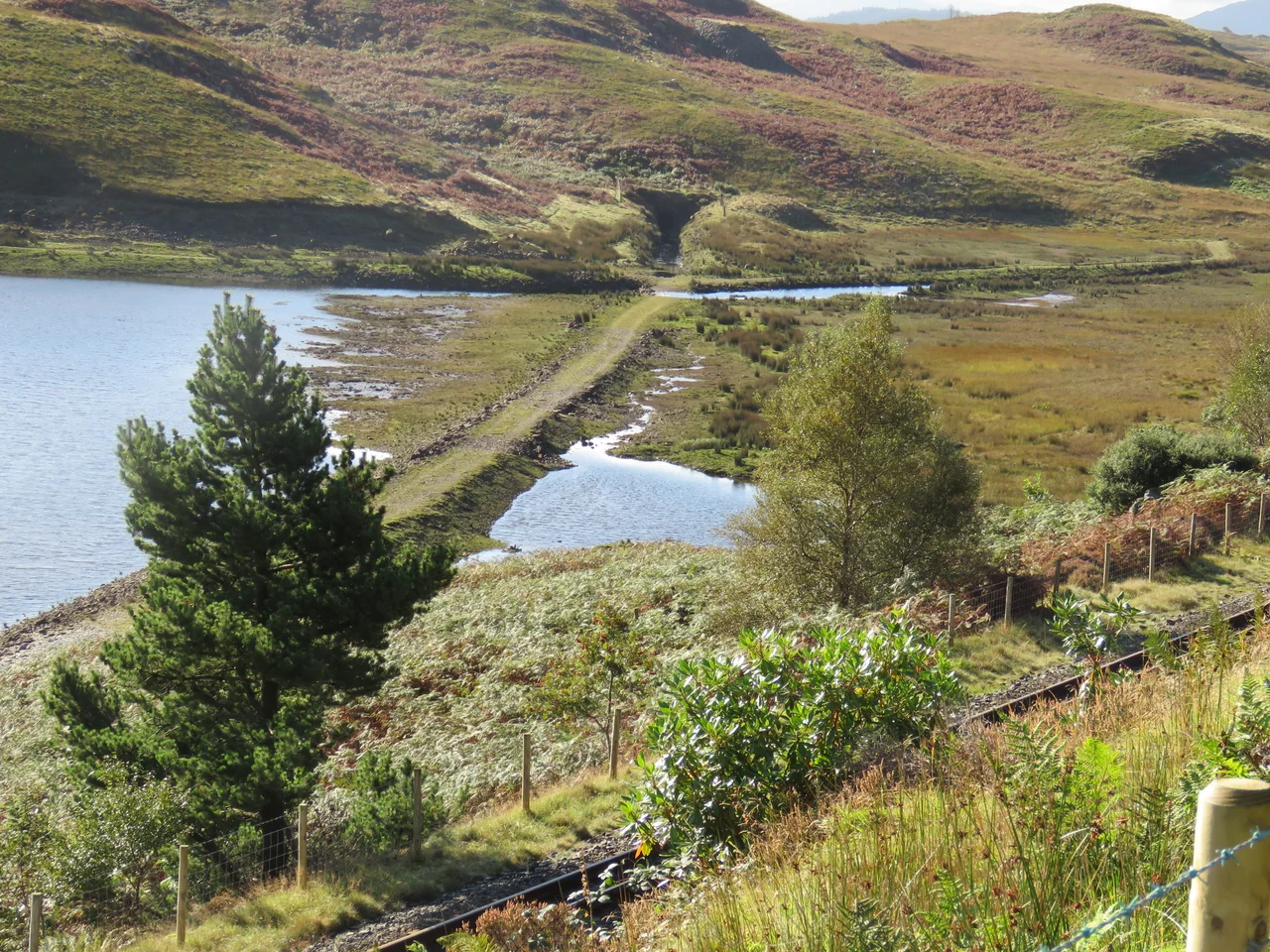 The old route of the Ffestiniog Railway and the northern portal of Moelwyn Tunnel, normally submerged below the waters of Tanygrisiau reservoir, but visible because of low water levels. The replacement FR route is in the foreground.
