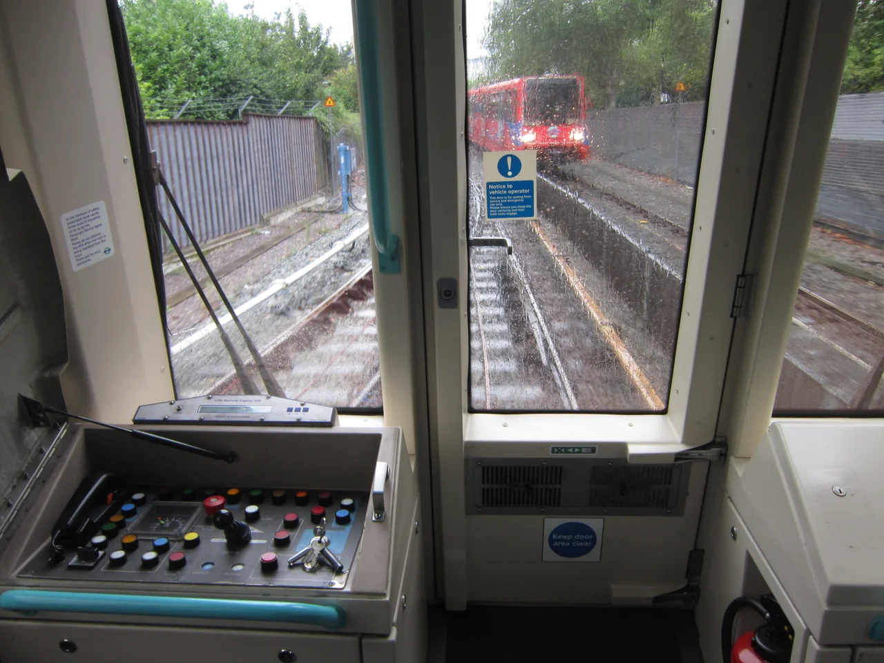 View from the front of Docklands Light Railway rolling stock B90, illustrating the closable control desk (normally locked) and the panoramic view available