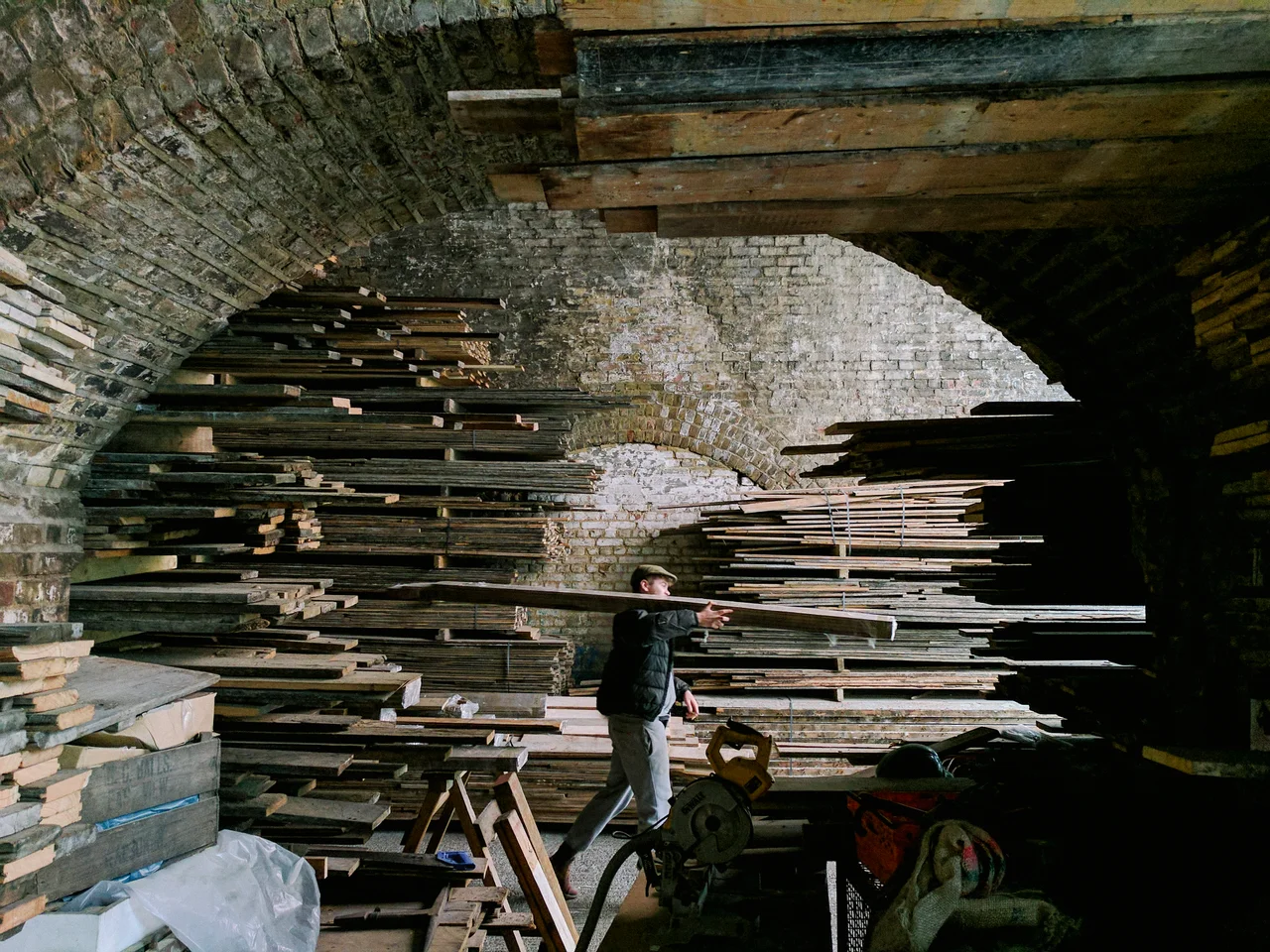 An image of a labourer in a reclamation yard on Maltby street during the week. The food market occupies this space on the weekend