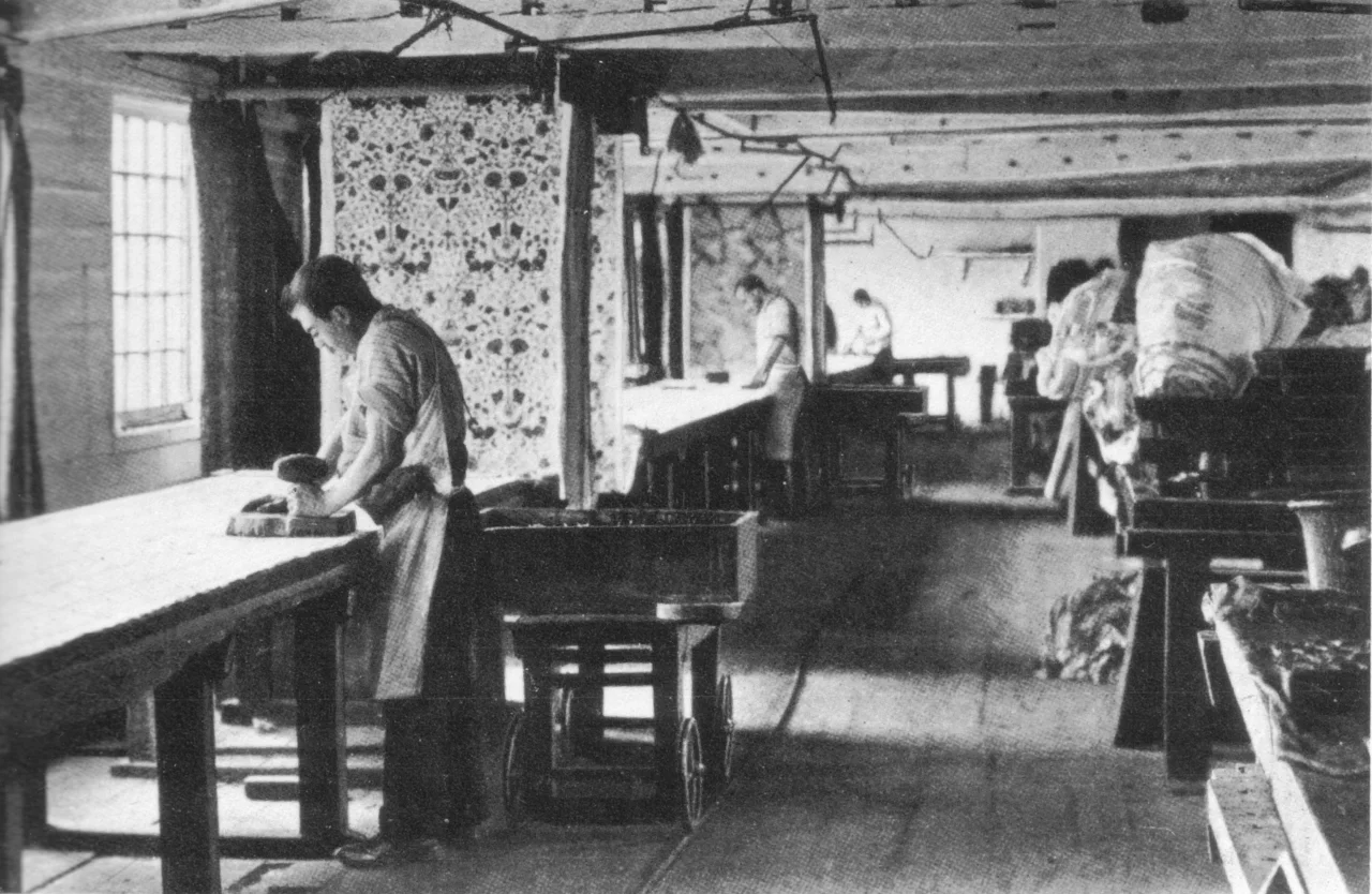 Printing chintzes at Merton Abbey c. 1890, first published in Morris & Company, A Brief Sketch Of The Morris Movement and of the Firm Founded by William Morris to Carry Out His Designs and the Industries Revived or Started by Him. Written To Commemorate The Firm's Fiftieth Anniversary In June 1911. Privately printed at the Chiswick Press for Morris & Company, 1911. (Date information from Gillian Naylor, William Morris by Himself: Designs and Writings, London, Little Brown & Co. 2000 reprint of 1988 edition.)