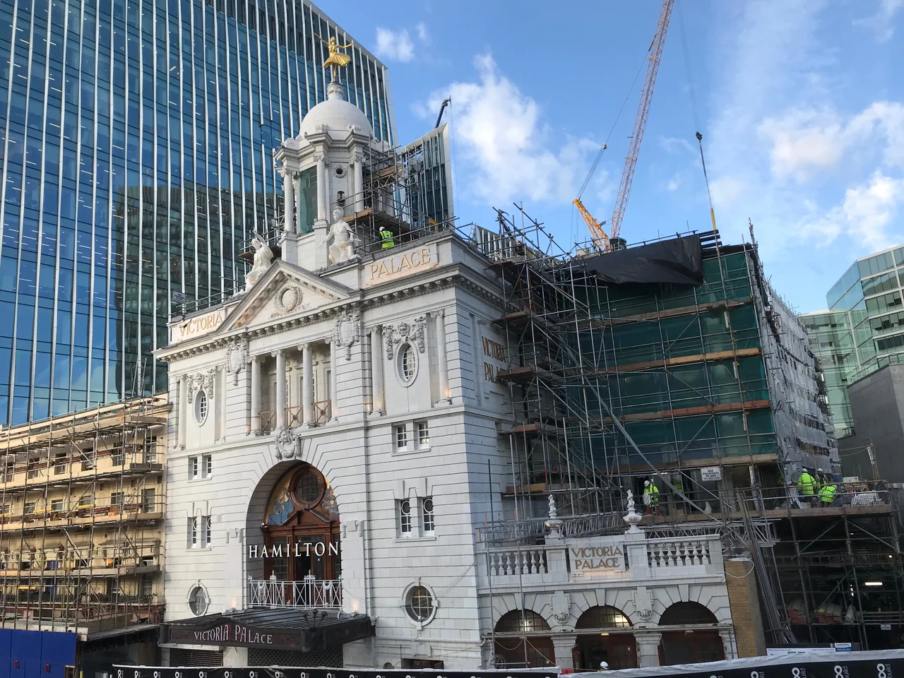 The Victoria Palace Theatre in London, shown as its 20 month refurbishment and rebuilding period nears its end. The faience façade has been cleaned, the original mosaic restored, and a seven-storey extension is almost complete to the side.