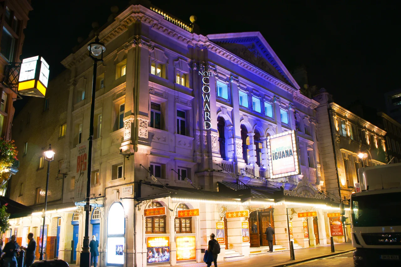 Noël Coward Theatre, London. Photograph taken in a public location in the UK of a building on permanent public display, and exempt from copyright under Section 62 of the Copyright Designs & Patents Act 1988 ("it is not an infringement of copyright to film, photograph, broadcast or make a graphic image of a building, sculpture, models for buildings or work of artistic craftsmanship if that work is permanently situated in a public place or in premises open to the public")