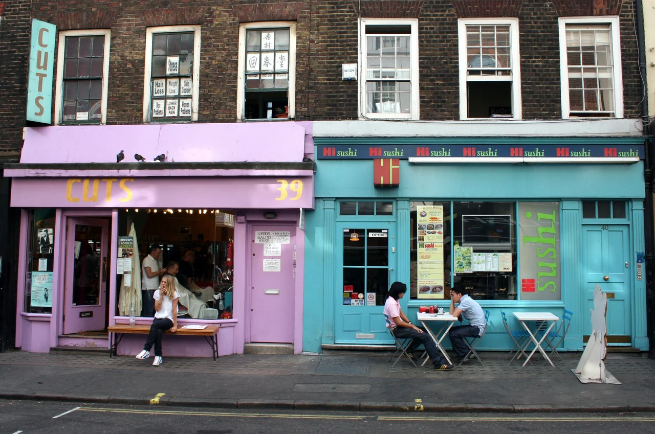 Colorfully painted shop windows in a typical Soho backstreet in London. 39-40 Frith Street, Soho, London W1.