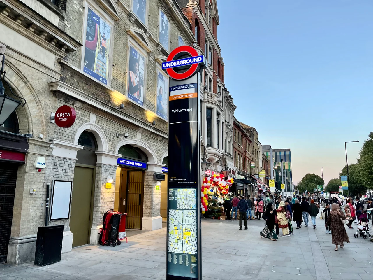 Whitechapel LU roundel totem pole, with white sticker over Elizabeth line signage