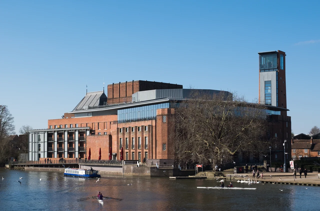 The Royal Shakespeare Theatre, Stratford-upon-Avon, England - viewed from the old tram bridge over the River Avon to the east. This is a grade II* listed building in England.