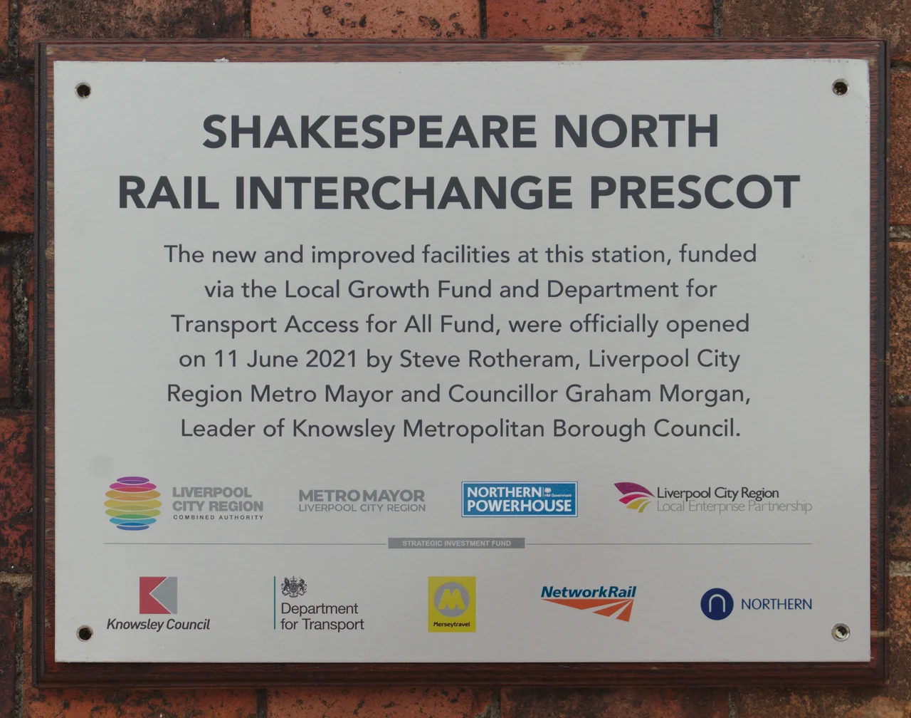 Plaque on the outer wall of Prescot railway station building commemorating its refurbishment and relaunch as Shakespeare North Rail Interchange in 2021
