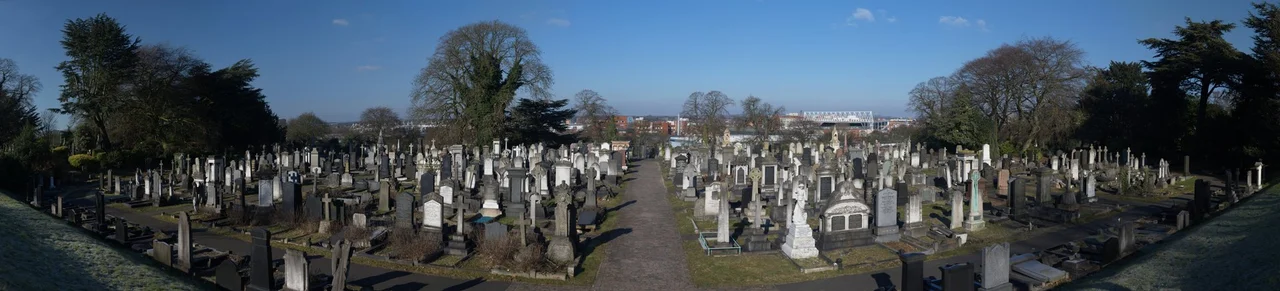 Welford Road Cemetery in Leicester. The photograph demonstrates the symmetrical layout of the cemetery: the area on the left is unconsecrated ground for non-conformists, while the area on the right is consecrated ground for Anglicans. There is a noticeable difference between the monuments in each area.