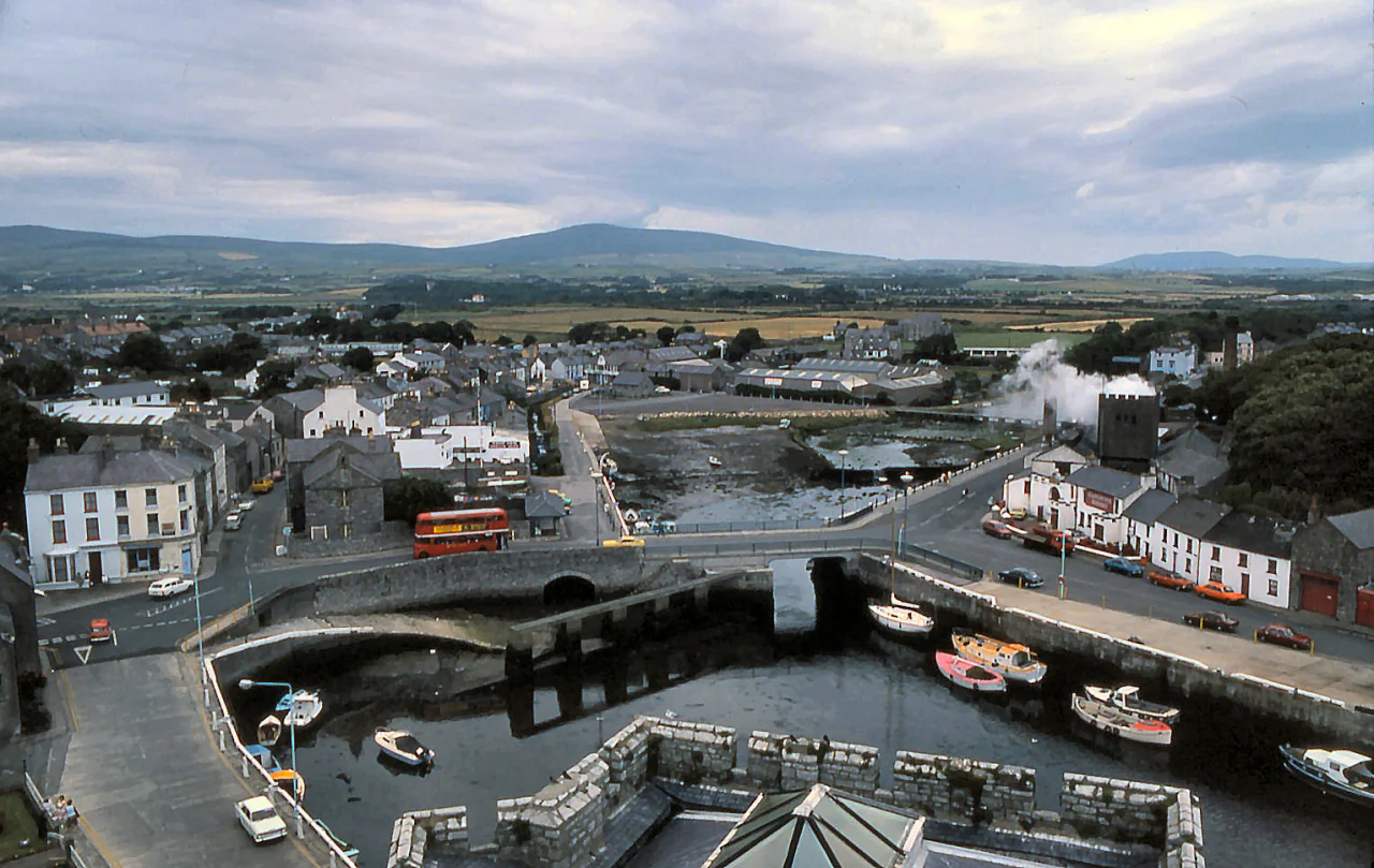A view of Castletown, Isle of Man, Great Britain, from Castle Rushen across the harbour and the bridge over Silver Burn. The red bus belongs to Isle of Man Road Services.
