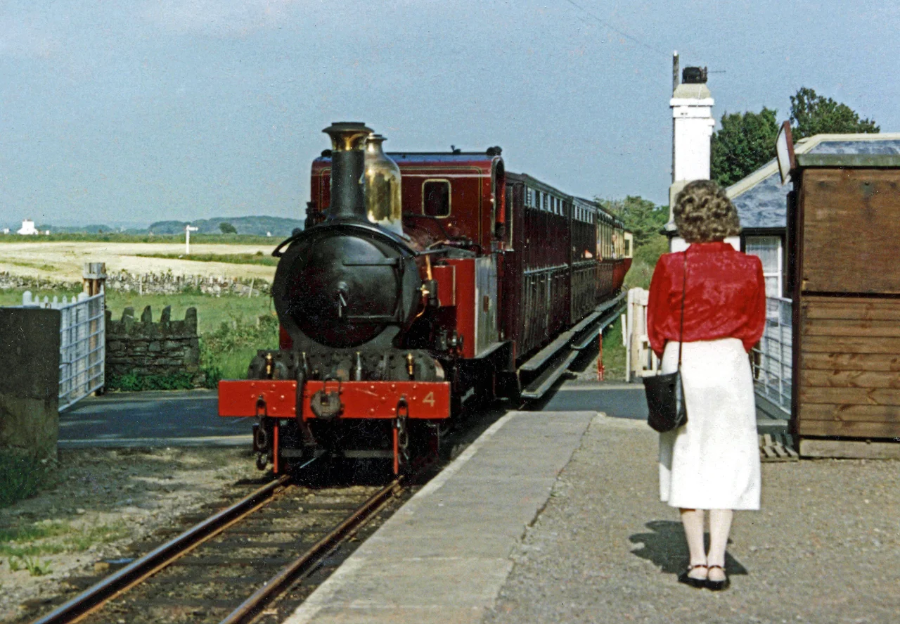 Port St Mary railway station with train from Douglas passing over the level crossing