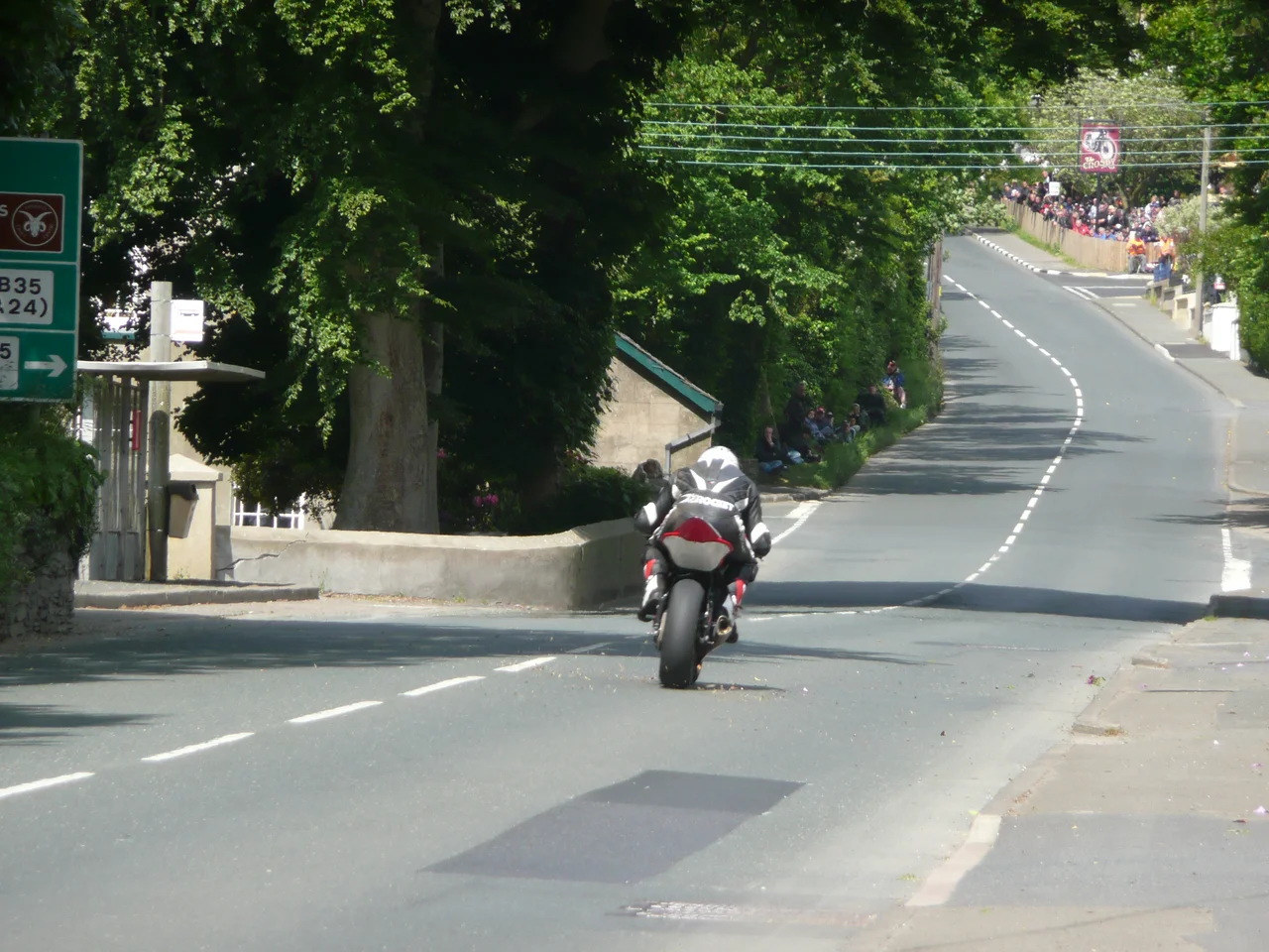 Unknown rider approaching Crosby Crossroads on the Isle of Man TT course during the Junior Supersport B TT race in 2008