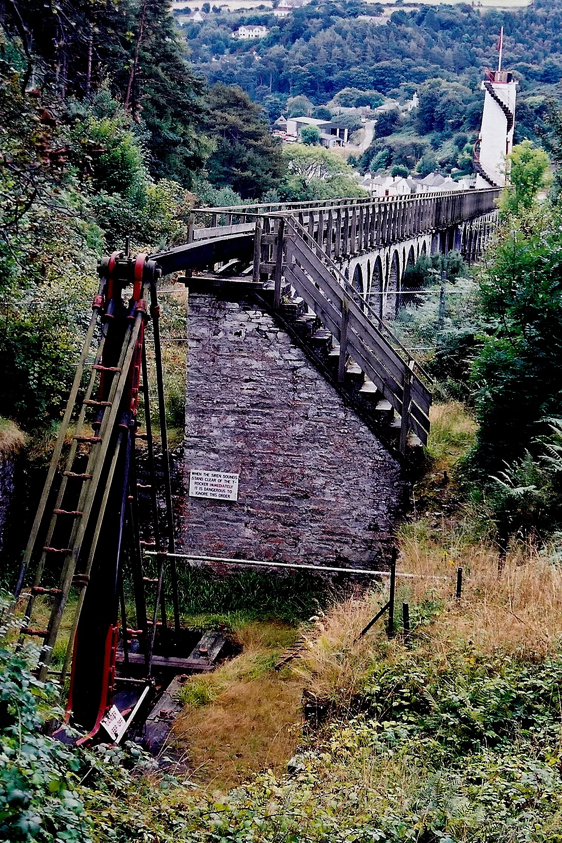 Laxey - The Mines Trail - T-Rocker View is to the southeast towards the T-Rocker. The T-Rocker converts the horizontal motion of the horizontal rod or shaft to a vertical motion down into a vertical mineshaft to pump water out of the deep mine.