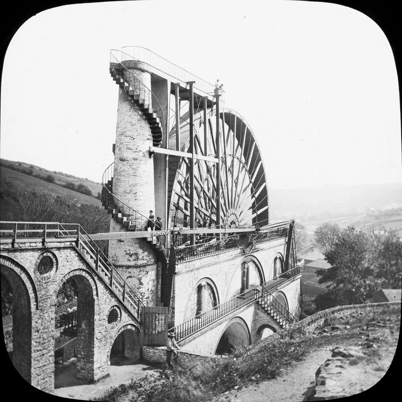 We continue today on the magical, mystery tour of the Mason catalogue. An "Elaborate technical wheel, possibly hydro electric generator, figures ascending" a spiral staircase no less - shouldn't be too hard to identify...?
....And indeed many immediately recognised this as the Laxey Wheel on the Isle of Man. Built in the 1850s, it was designed to pump water from the Laxey mine - and is now something of a symbol of the island.
Photographer: Thomas H. Mason
Collection: Mason Photographic Collection
Date: Circa 1890 - 1910
NLI Ref: M50/18
You can also view this image, and many thousands of others, on the NLI’s catalogue at catalogue.nli.ie