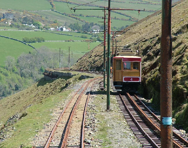 Cars pass on the Snaefell Mountain Railway, Isle of Man with the hamlet of Agneash just visible in the distance.