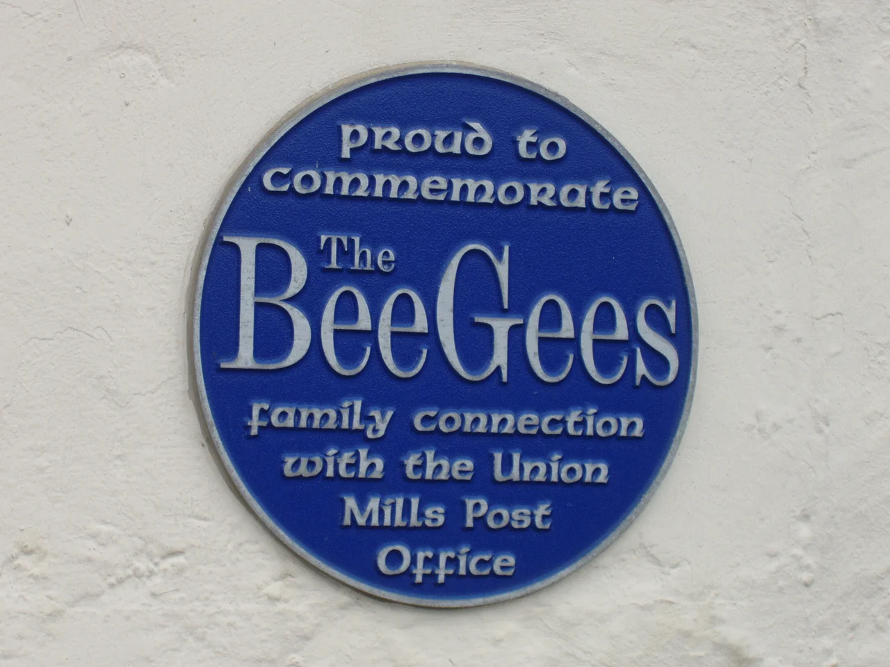 Plaque commemorating the Bee Gees connection to the Isle of Man.  This is affixed to the exterior wall of a grocery store at the intersection of Maitland Terrace and Strang Road in Union Mills, Isle of Man.