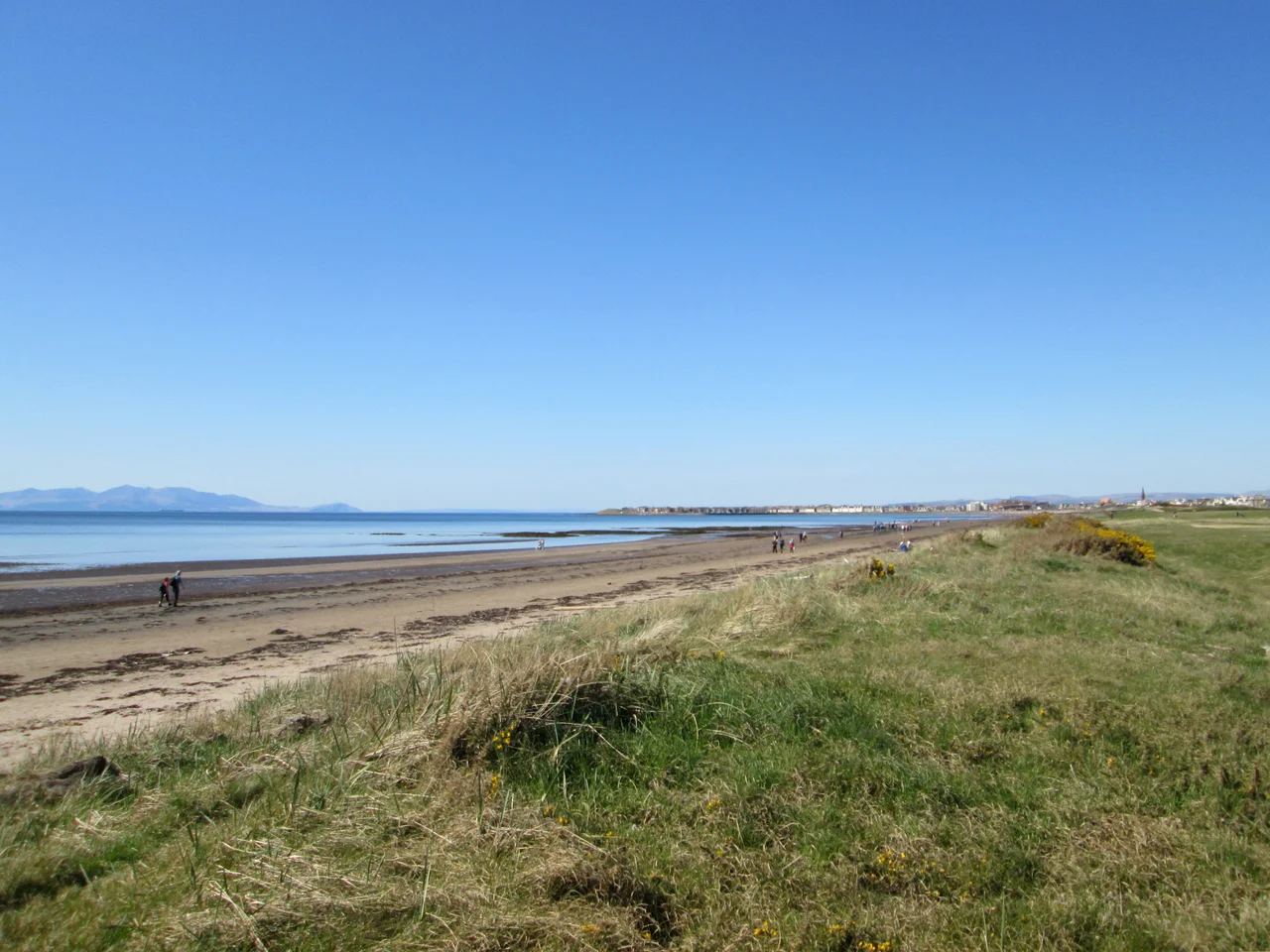 View from top of sand dunes forming the perimeter of the Royal Troon Golf Club course, looking out over the Firth of Clyde towards the Isle of Arran and north over South Sands and South Bay to Troon.