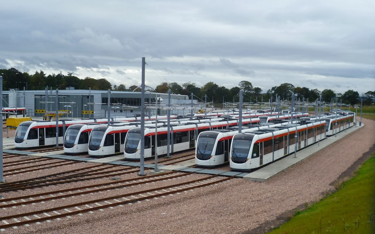 Edinburgh Trams in the Gogar Tram Depot. The first tram arrived in April 2010, and by now most had arrived - the last of the 27 strong fleet arrived in December 2012. Testing began in December 2011 on what little track had been completed in the area of the depot - it wasn't until May 2014 that the system opened. Such were the delays and cancellations, that only 8 trams are needed to run the peak service.