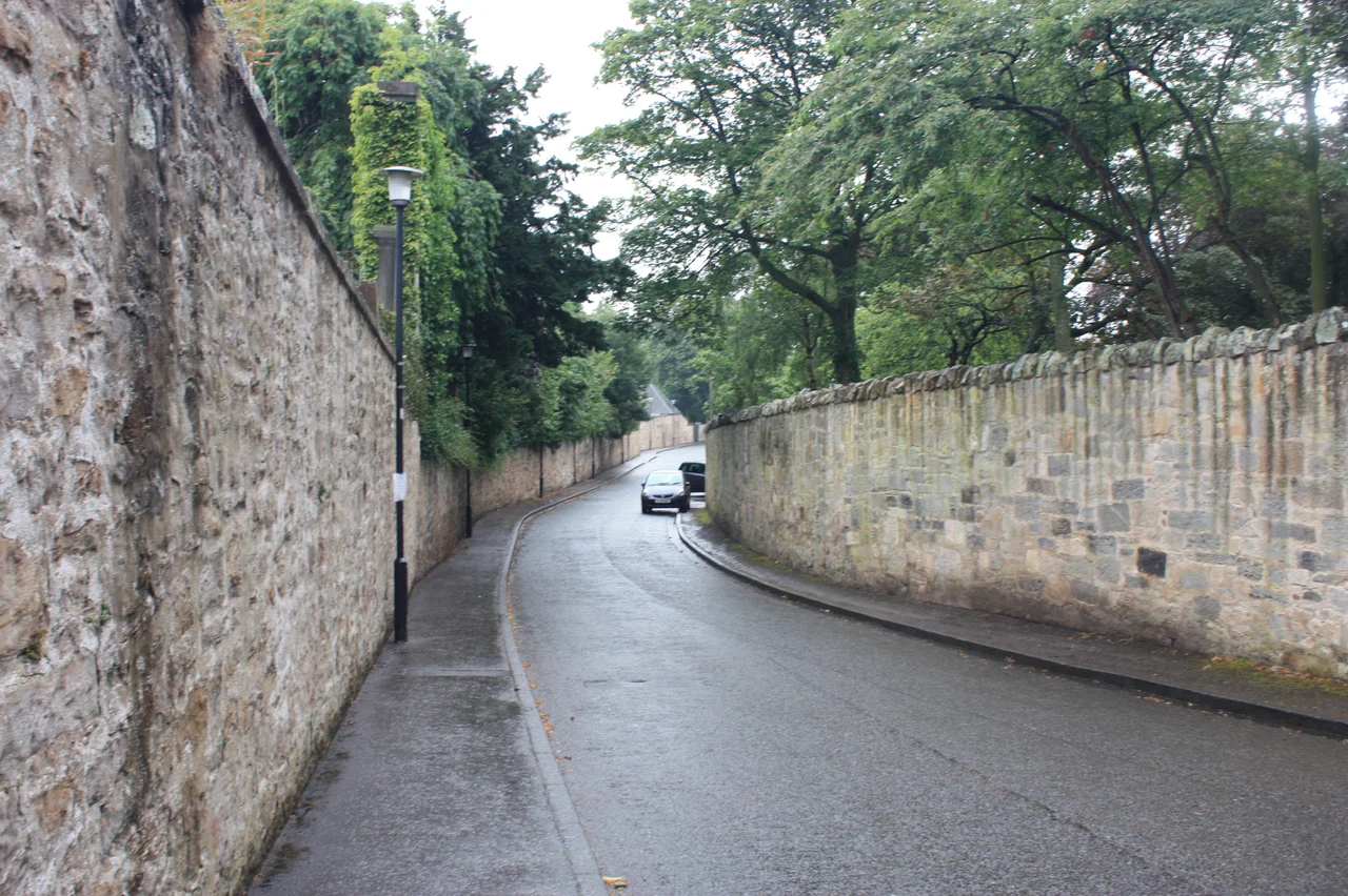 The western section of Inveresk Village is typified by high stone walls and mansionhouses screened by trees