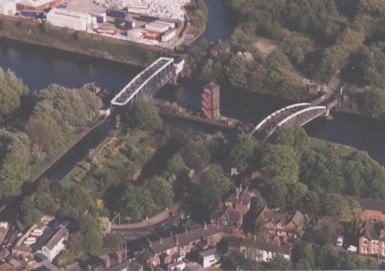 Aerial view of the SW part of Barton showing the Ship Canal, Bridgewater Canal, bridges and housing.