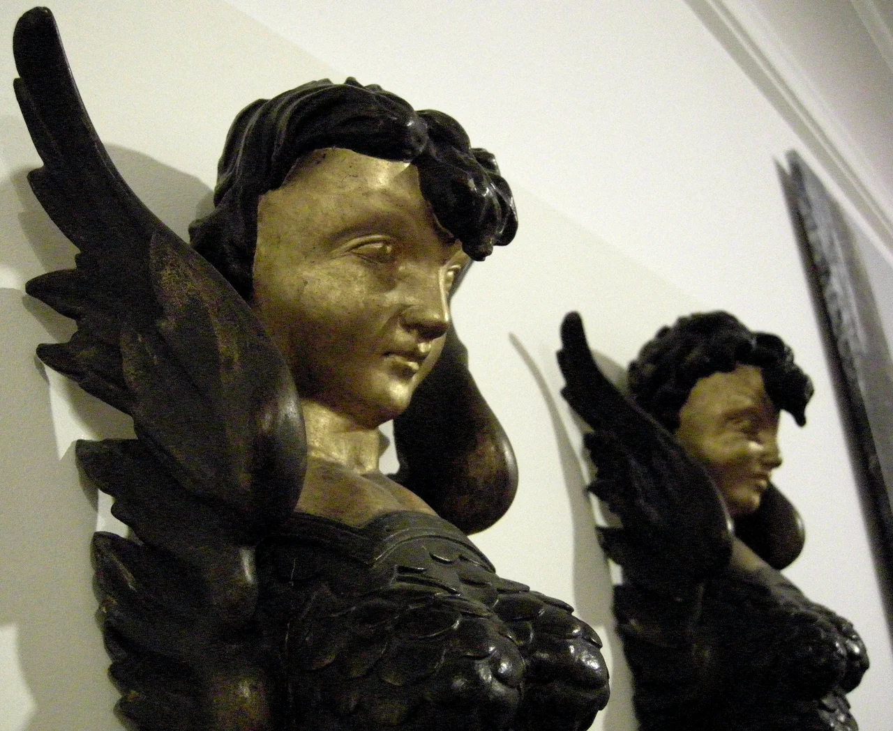 Carved wooden harpies from 19th century "Chinese Chandelier", in Mansion to Museum gallery, Cliffe Castle Museum, Keighley, West Yorkshire, England.
