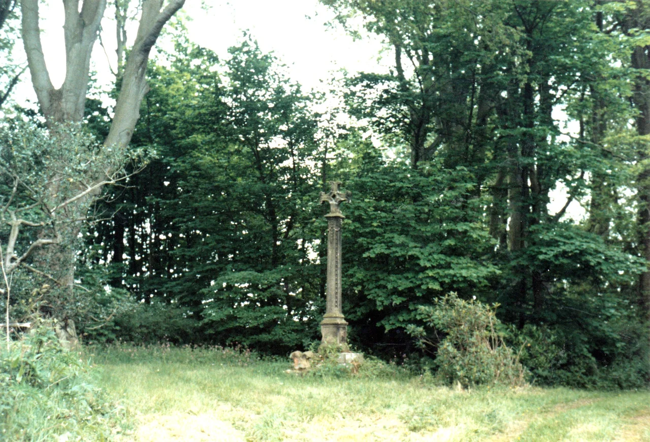 Stone memorial cross erected by the Duchess of Northumberland in 1774 in memory of King Malcolm III (Canmore) of Scotland who was killed on or near this spot while besieging Alnwick Castle in 1093. Legend has it that the castle's Steward rode up to the Scottish king to surrender the keys of the castle in the time-honoured tradition of passing them over on the end of his lance. However, once within arm's range of the king, he decided to use his lance to greater effect by treacherously slaying him on the spot.