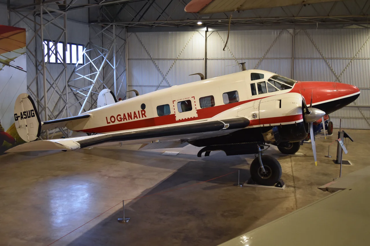 c/n BA-111
Built in 1955, this E.18 was used as a corporate transport in the US until 1964 when it flew to the UK and was modified for surveying work which included fitting a transparent nose cone. It joined Survey Flights Ltd in Northern Island who operated it until 1968, when it joined the Scottish Airline Loganair.
Converted to a nine-seat passenger layout, it then operated the airlines passenger and newspaper routes. In July 1969 it carried out the airlines first international service when it flew from Glasgow to Stavanger, Norway, via Aberdeen. During its time with Loganair it also served as an Air Ambulance, due to its long range capability.
It was retired in March 1975 due to the cost of an upcoming wingspar inspection, but by March 1976 it had been safely preserved as part of the Scottish national collection.
It is currently on display in the Civil Aviation Hangar at the National Museum of Flight (part of National Museums Scotland).
East Fortune Airfield, East Lothian, Scotland.
13th September 2017.