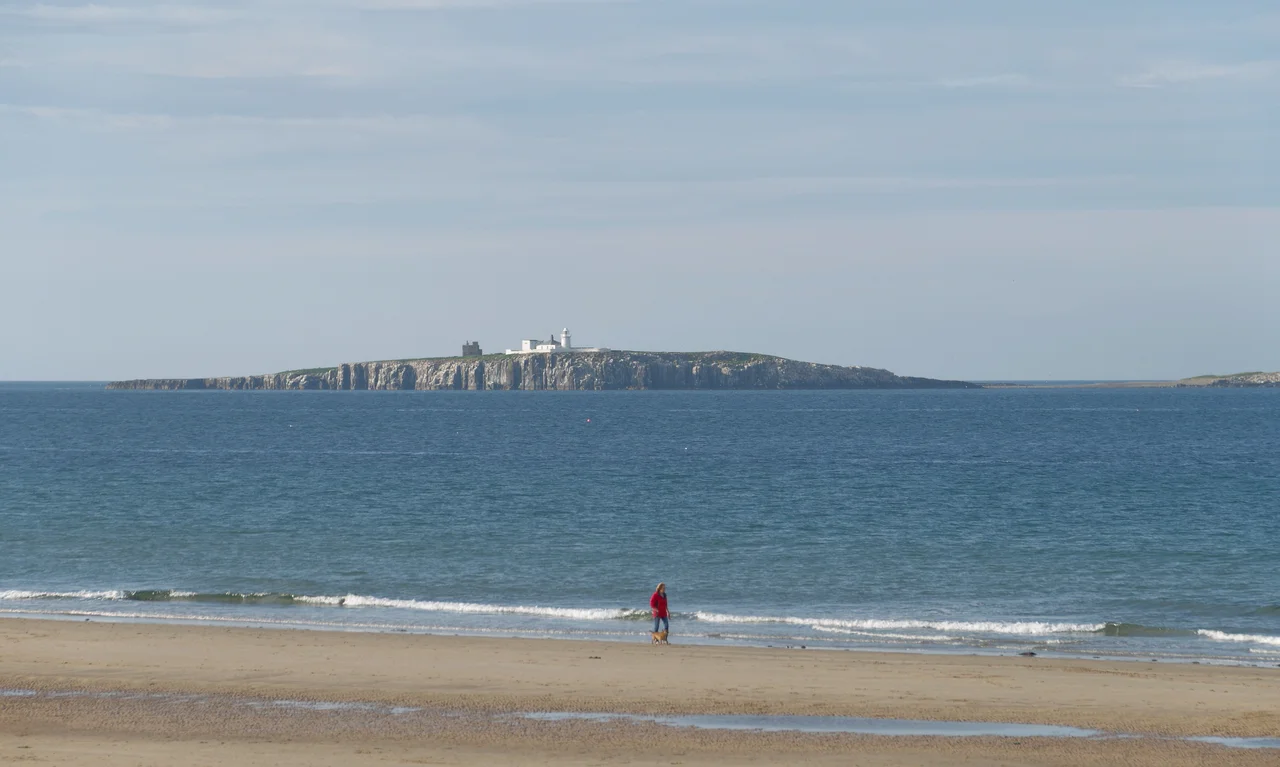 Looking out to sea towards the Farne Islands from the beach by St Alban's Dunes, north of Seahouses in Northumberland.
