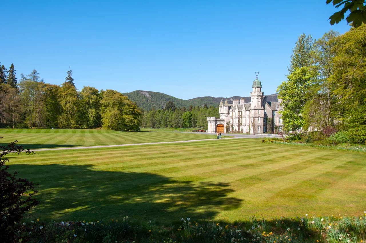Balmoral Castle. The Royal Standard of Scotland flies over it.