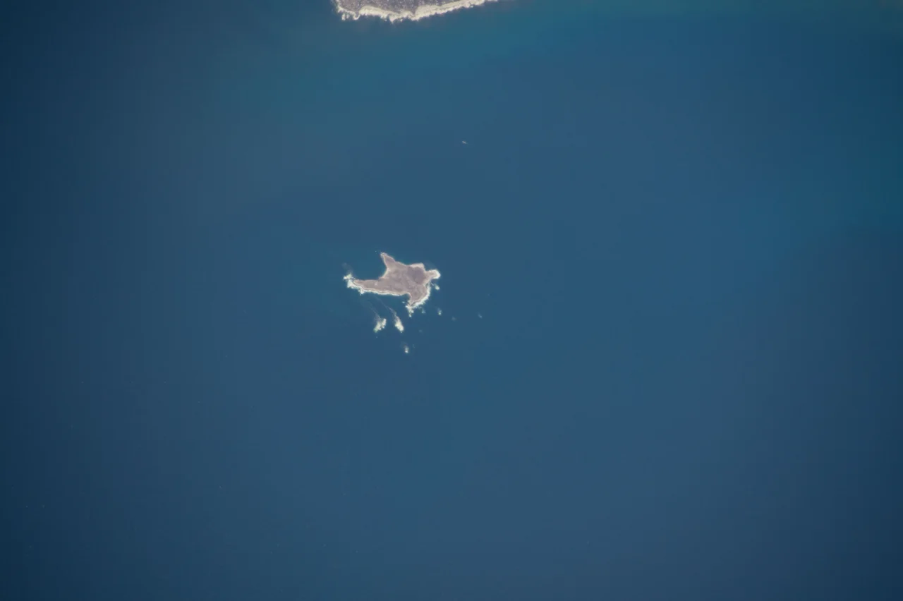 Dassen Island and lighthouse, 9 km off the coast of Yzerfontein. Lighthouse is 28 m, circular iron tower with white and red bands. 1893