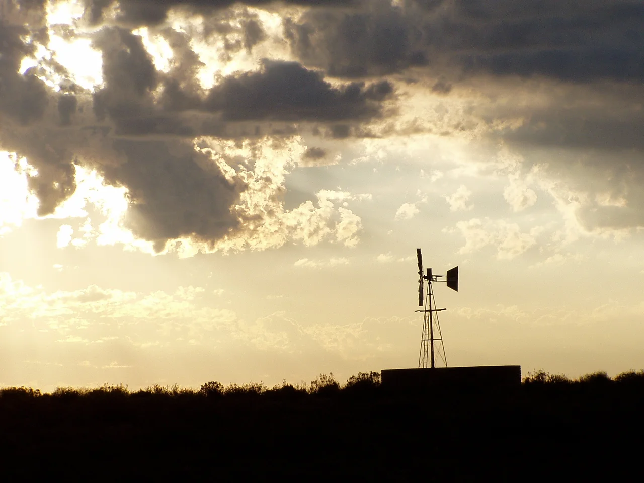 Sunset in the Great Karoo, near Sutherland, with a multi-bladed windpump, which has made permanent settlement and farming possible in this thristy land. These windpumps are iconic of the Great Karoo.
